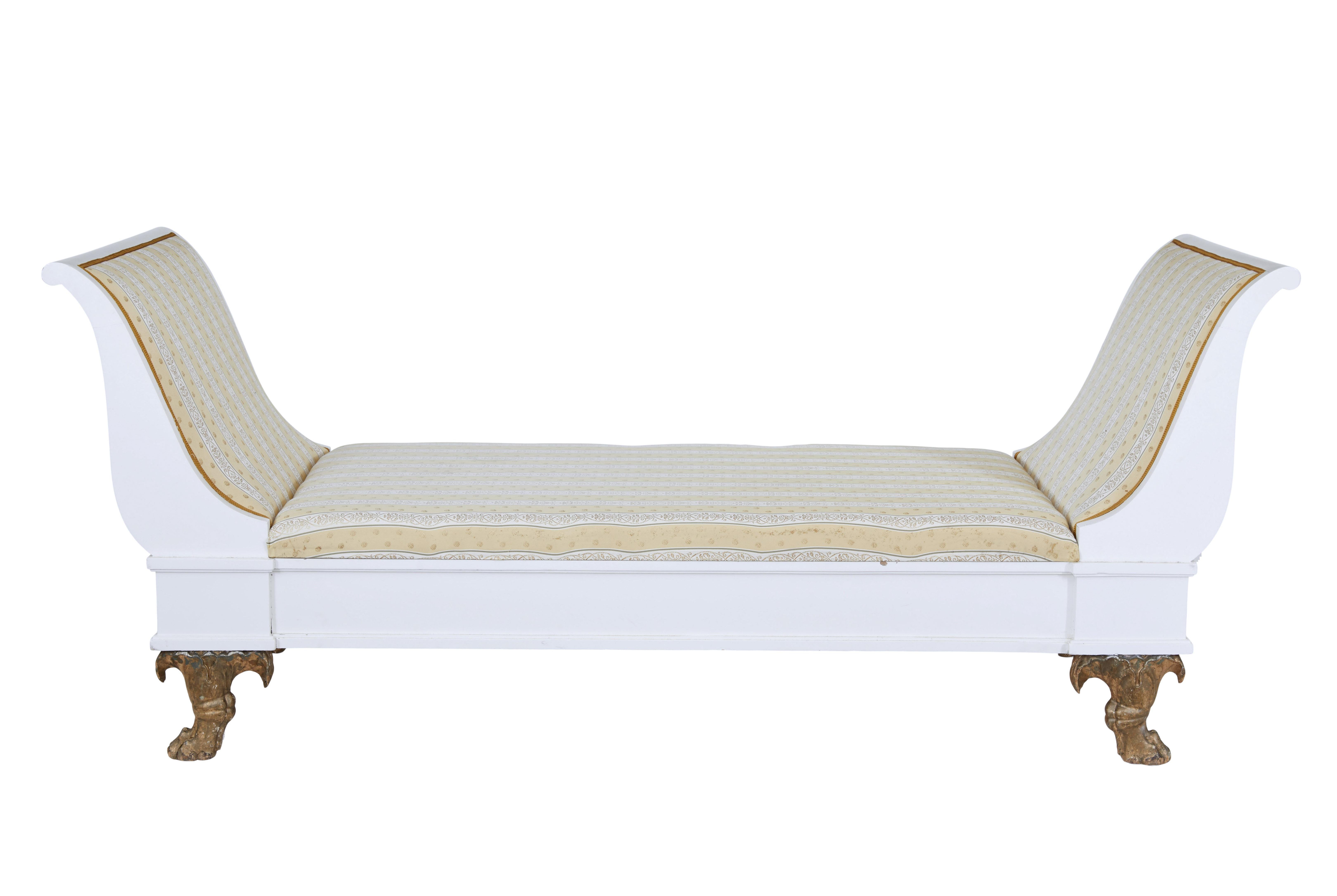 Early 20th century empire revival painted Scandinavian day bed circa 1900.

Grand sized Swedish day bed featuring scrolled end supports.  Pine frame has been later painted white, standing on carved paw feet with original gilt and traces of original