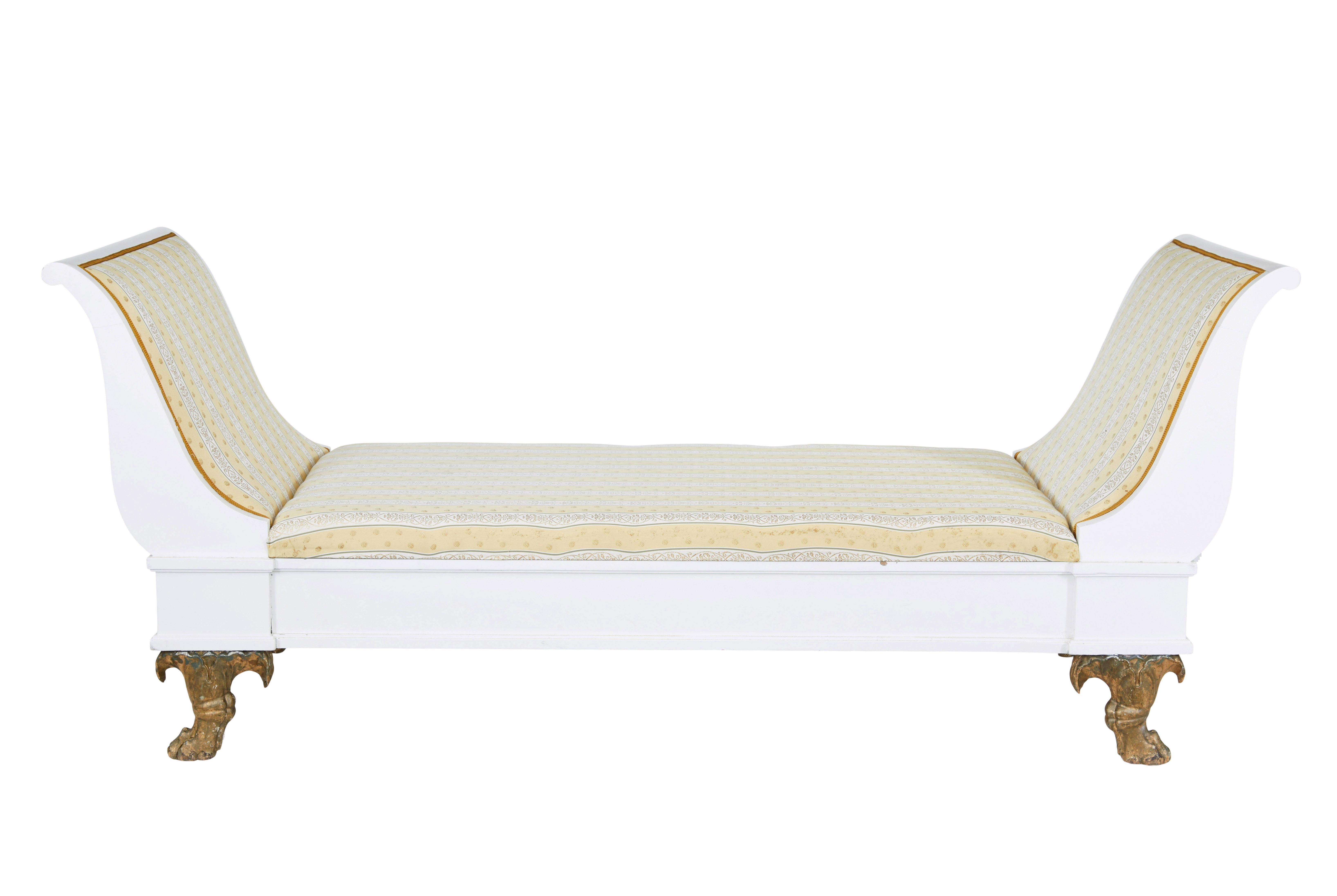 Early 20th century empire revival painted scandinavian day bed circa 1900.

Grand sized swedish day bed featuring scrolled end supports.  Pine frame has been later painted white, standing on carved paw feet with original gilt and traces of original