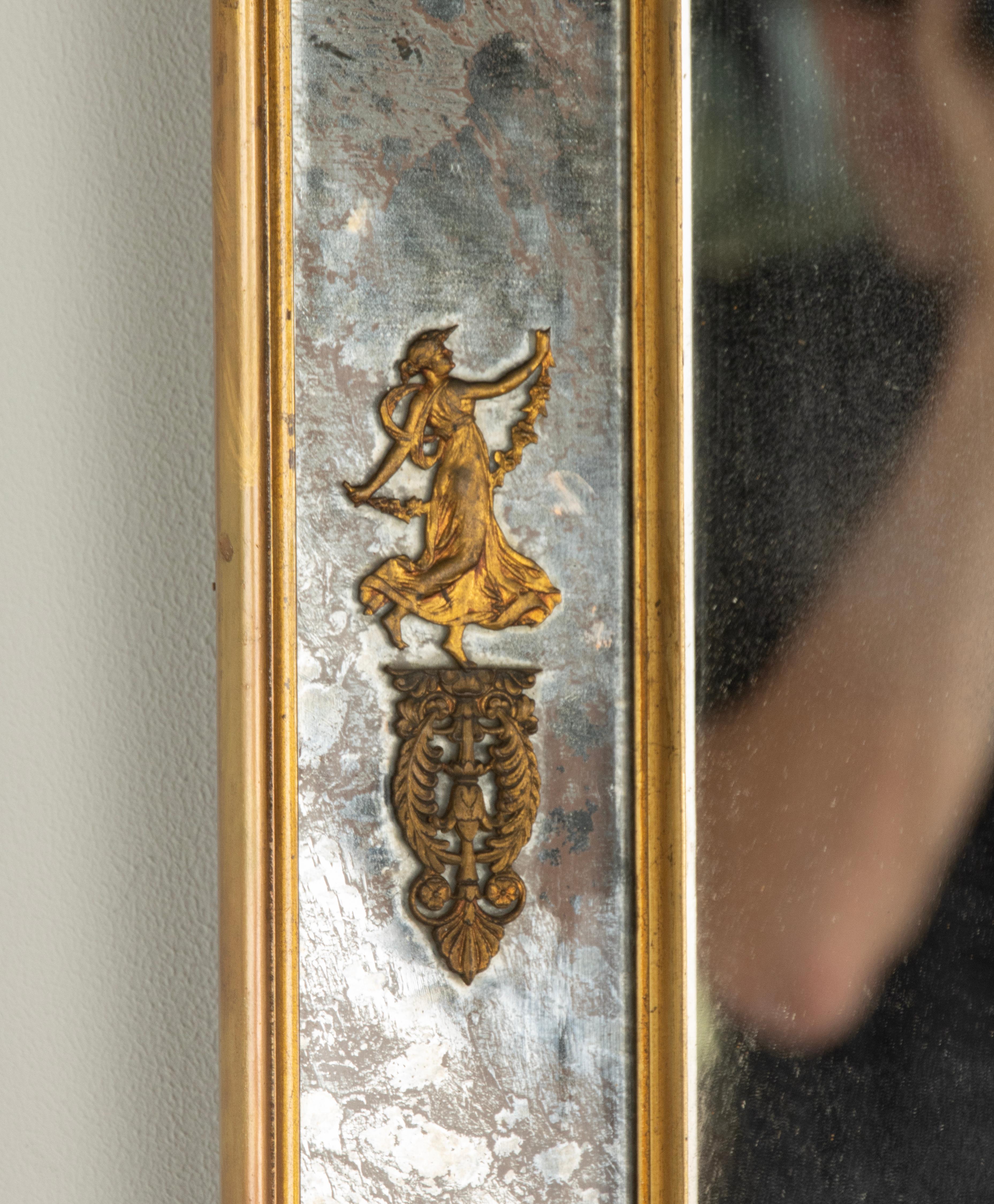 A beautiful antique mirror, stylish design. The mirror glass in the center is clear. The glass on the sides is cloudy, with a beautiful drawing and features bronze decorations in Empire style.
The mirror dates from approximately 1920-1930.

The