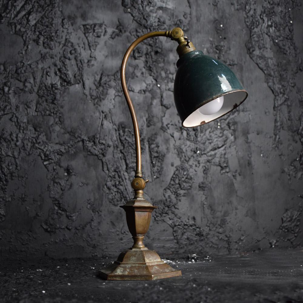 Early 20th century English Articulated brass C arm lamp
An unusual example of an early 20th century English brass C arm articulated lamp. Stamped 1027 at its base with a full adjustable mid and shade section. Light held through a green enamel