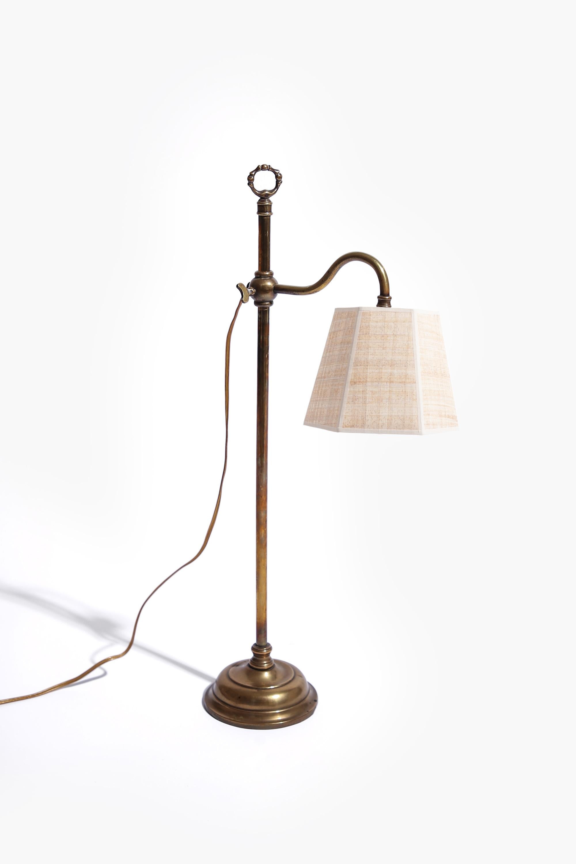 A good quality early 20th Century English brass 'student's lamp' with carrying handle.

Shown here with a hexagonal papyrus shade, available separately.

Nice original condition. Supplied wired to specification with silk flex.
