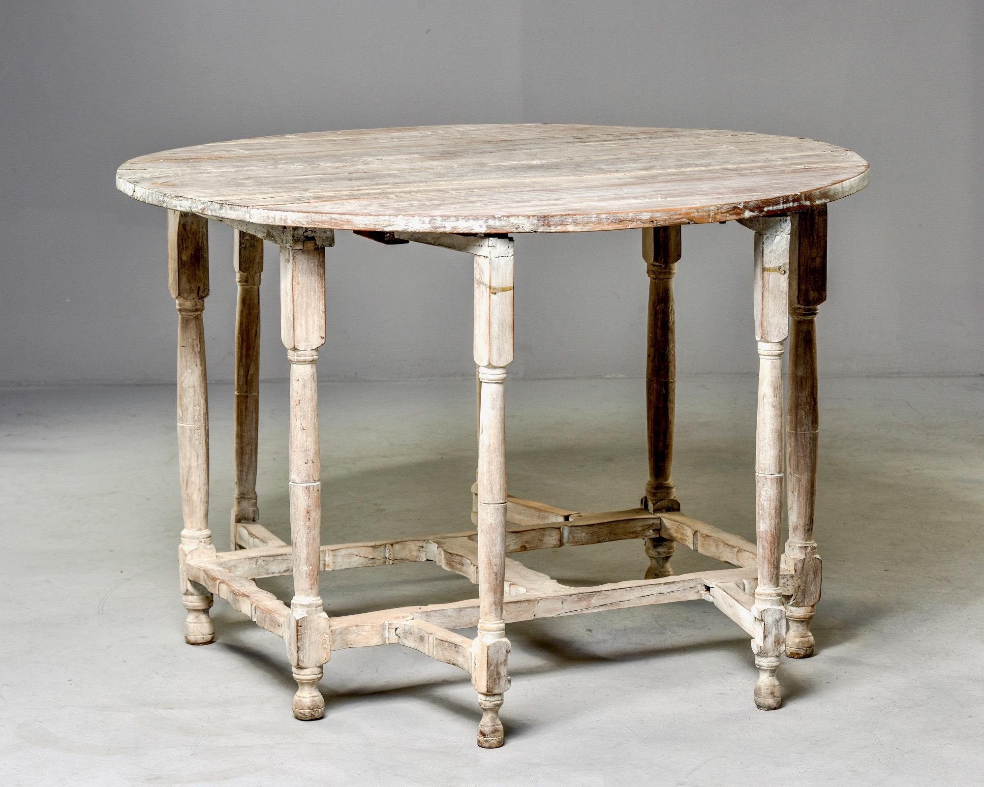 English gate leg oak table with cerused finish, circa 1900s. Measurements shown are with both sides extended. With both sides down, table measures 24.25” deep. Unknow maker.
   