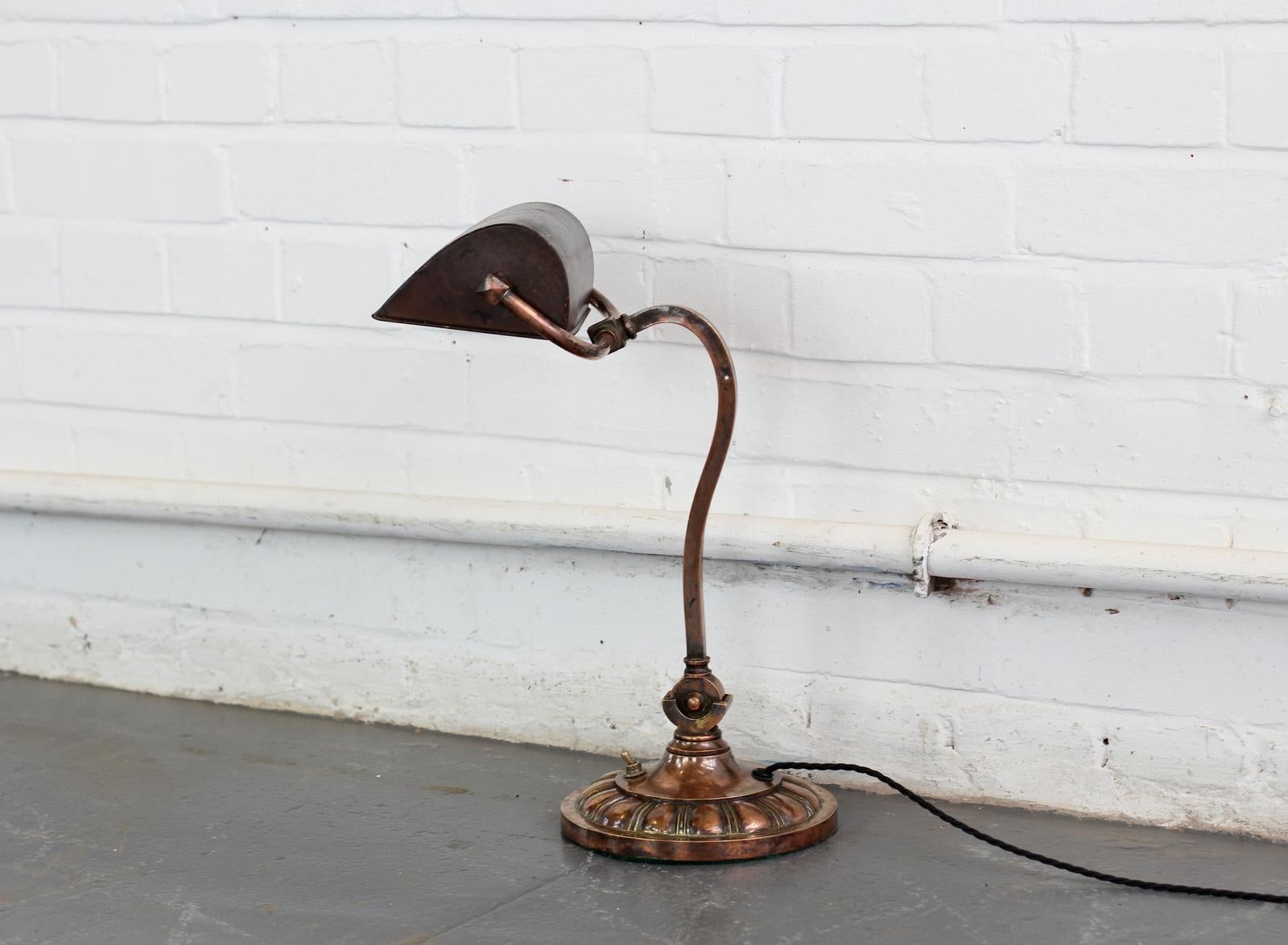 Early 20th century English copper desk lamp, circa 1910

- Beautiful detailed base
- Brass switch
- Takes B22 fitting bulbs
- Black braided cable
- English, circa 1910
- Measures: 44cm tall x 27cm wide x 24cm deep

Condition