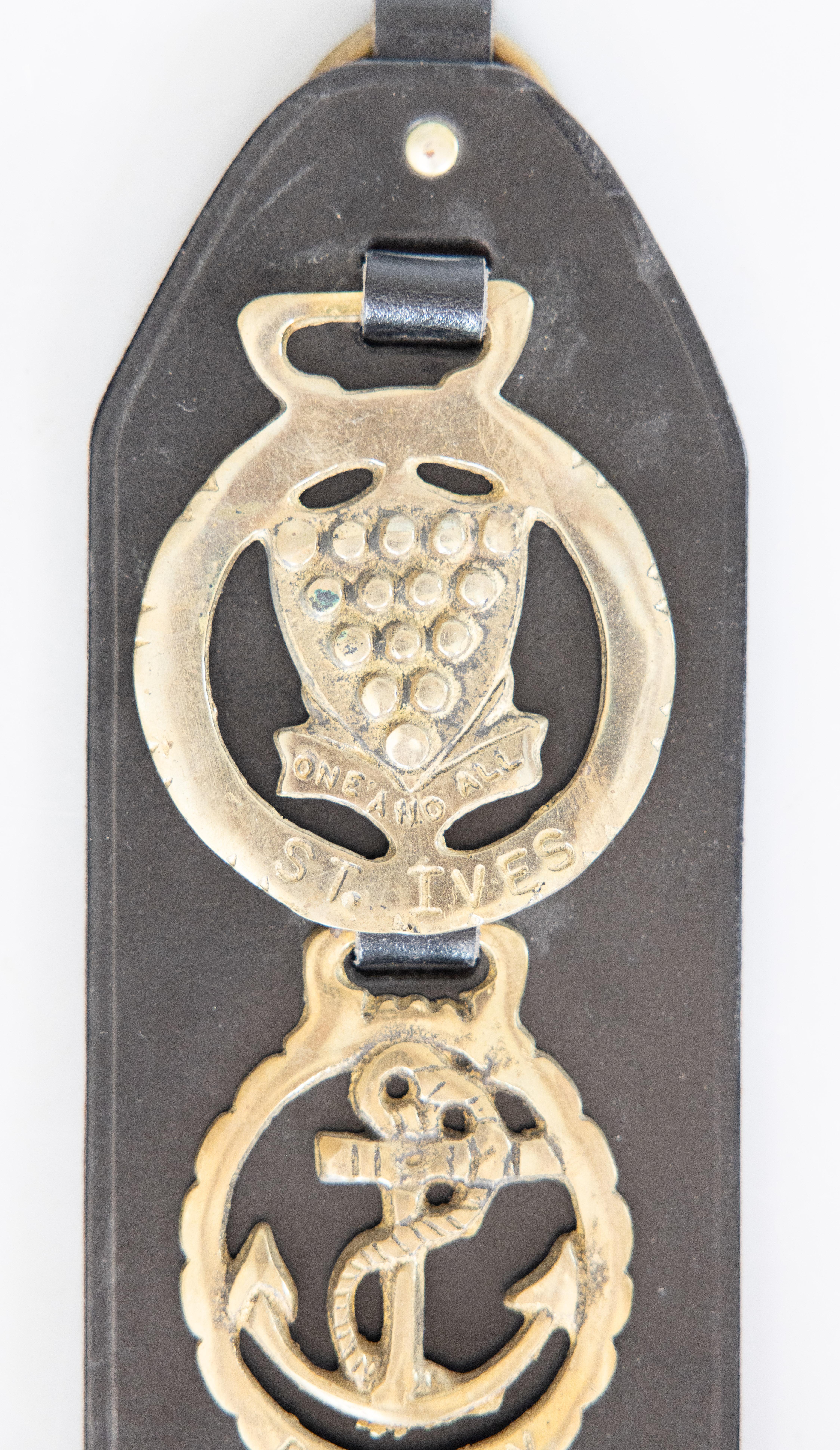 An antique early 20th Century English equestrian three brass leather horse strap. Horse brasses have their origins in ancient Rome, where they were used to embellish horse harnesses, and later became popular in medieval England as a method to