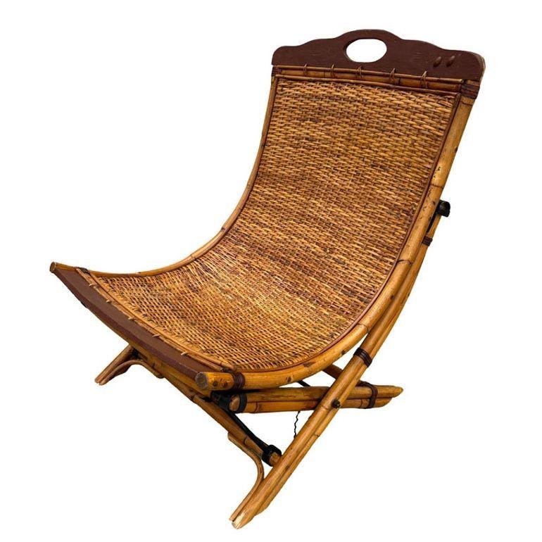 Early 20th Century folding English bamboo garden Chair. Originating from Europe in the late Edwardian period, this chair combines bamboo, wood, and leather materials, standing at 37 inches tall with a width of 25.5 inches and a depth of 27 inches.