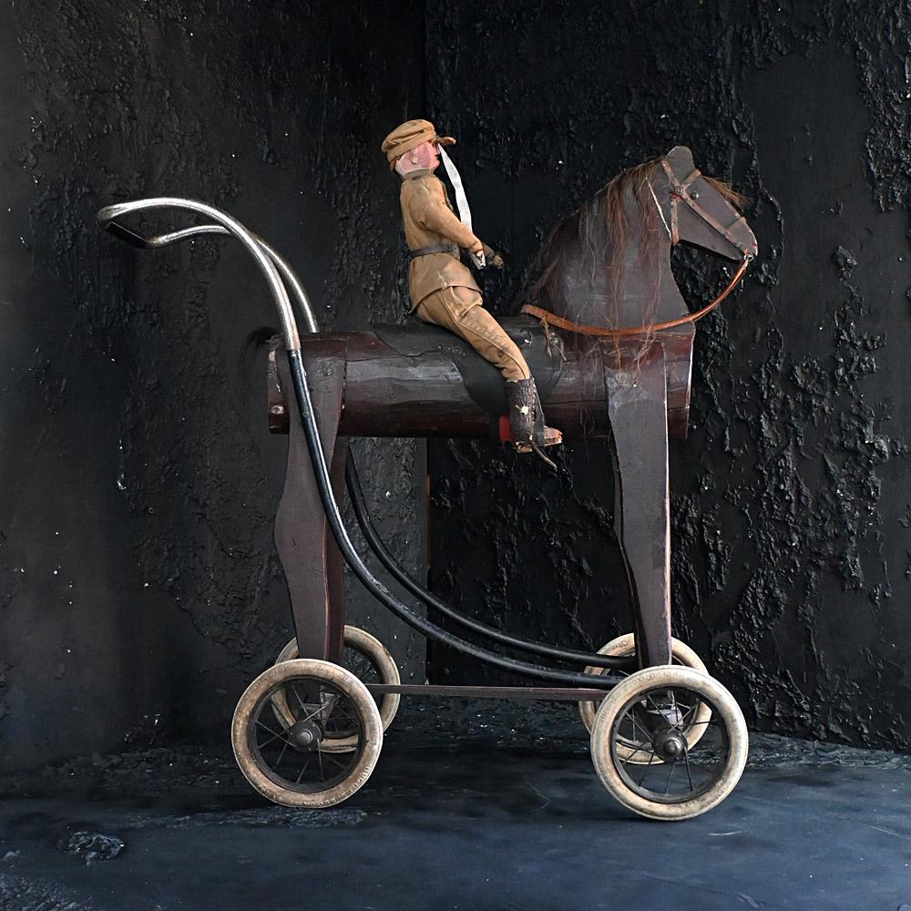 Early 20th Century English Folk Art Childs Toy 
We share what we love, and we love this adorable piece of English folk art toy. A hand-crafted officer figure sat on a scratch built horse on wheels. Made from found objects one would assume this toy