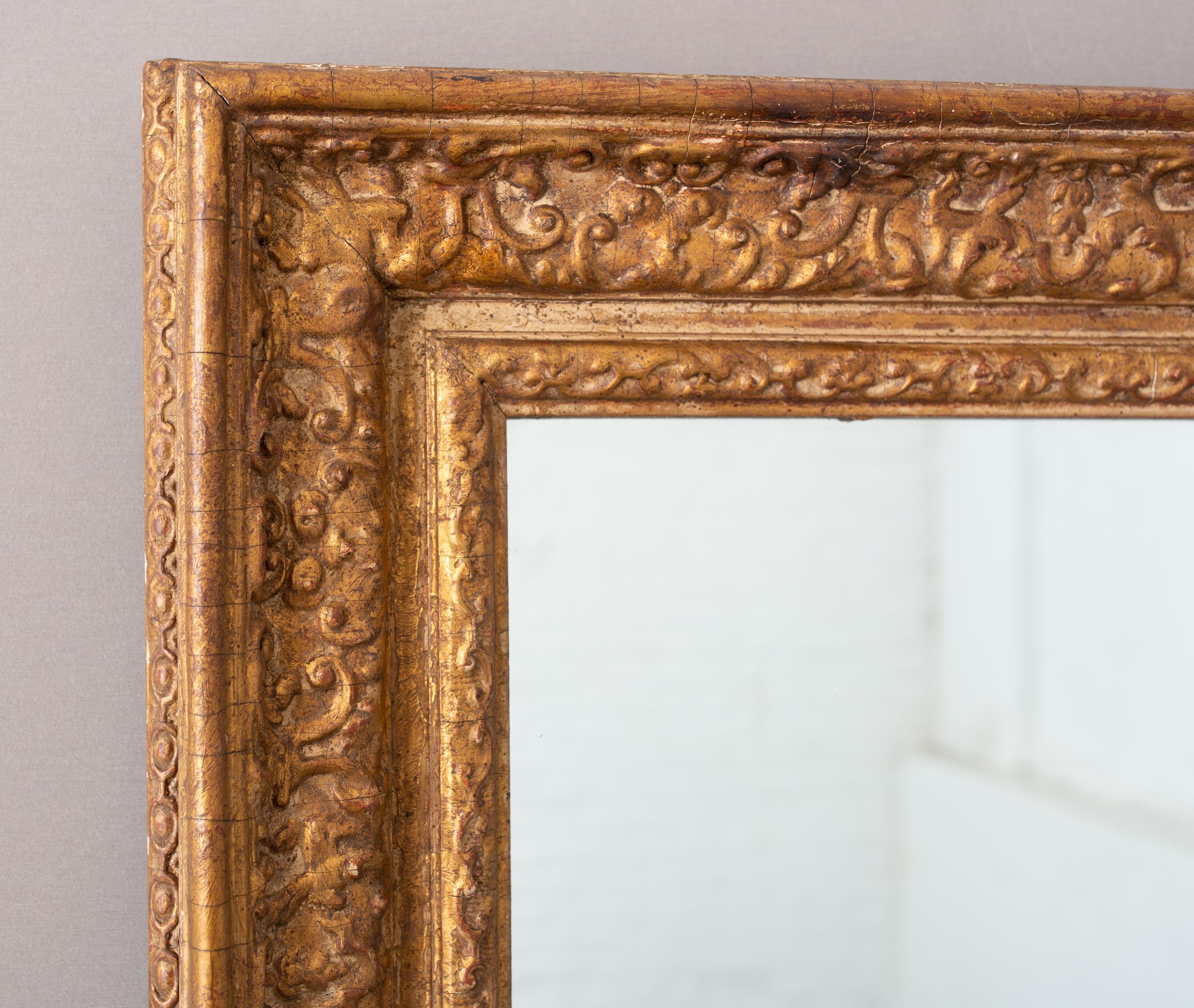 Early 20th century English gilt painted mirror with great age. Foxing detail to mirror. Wood in original condition. Some losses to wood but it all goes with the overall style of the mirror! Please see all photos.