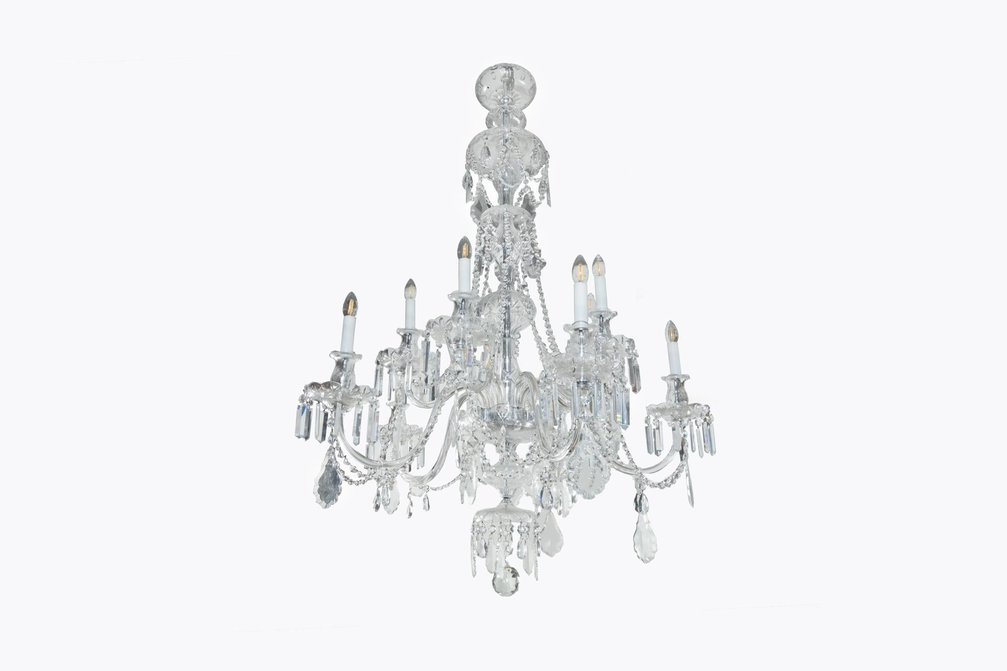 Early 20th Century English glass chandelier with 10 arms and cut glass drip pans. It originally hung in the drawing room of an 18th Century estate house outside Bath in England.