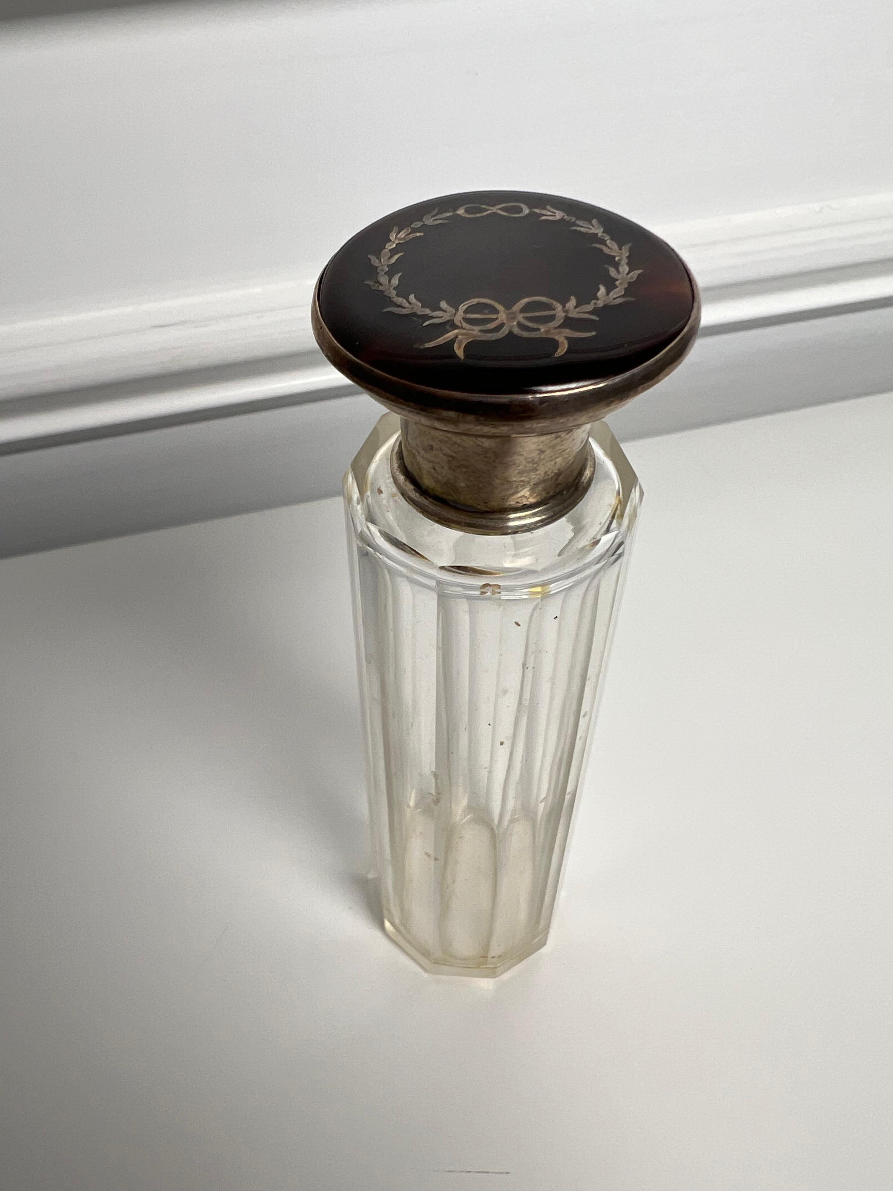 This is a nice early 20th century glass jar with a tortoise shell lid with sterling silver inlay. The jar is 10 sided with a sterling silver rim and is a unique size. Purchased by a private collector in Birmingham England who traveled the world