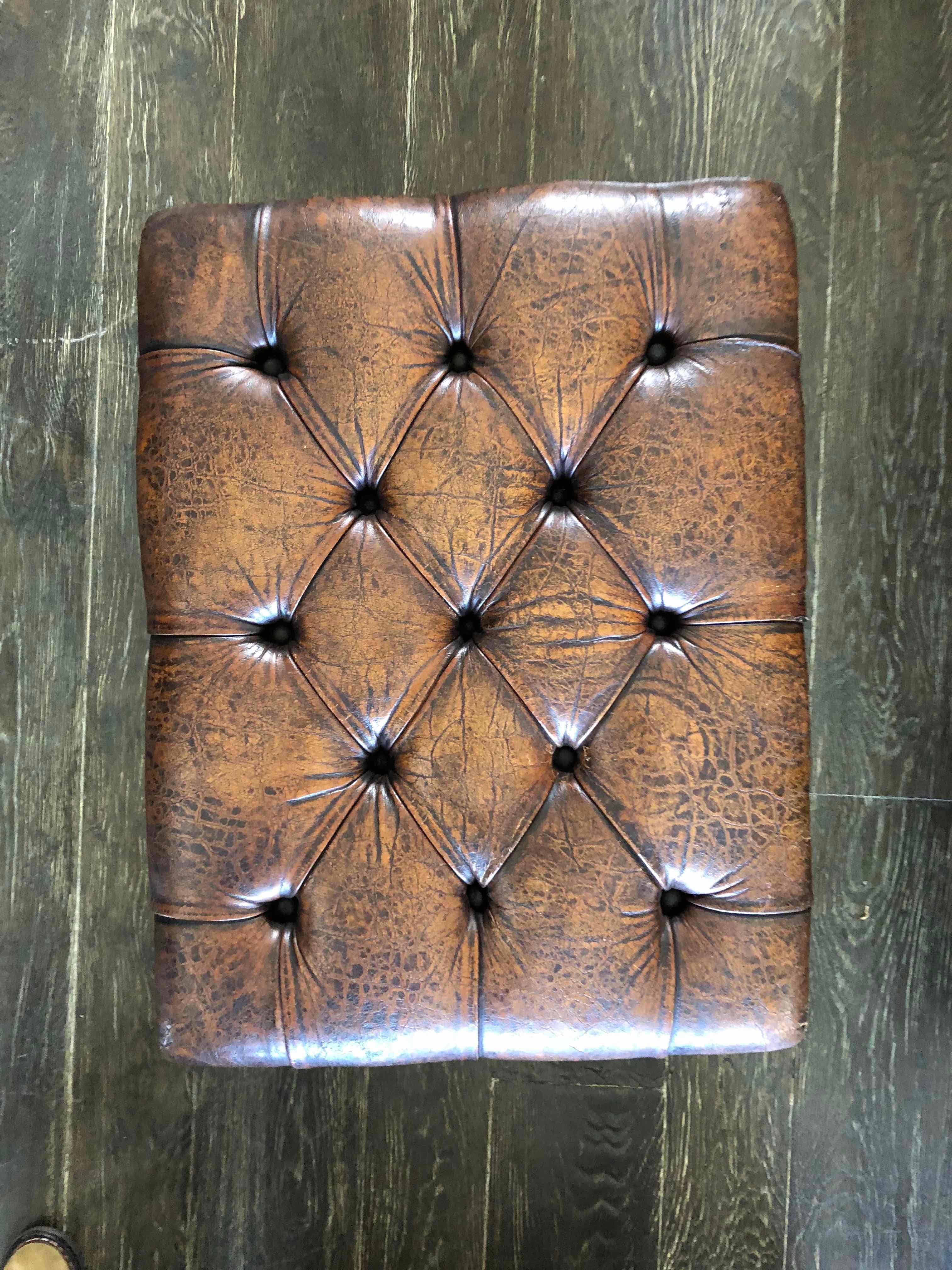 Early 20th century English leather footstool or bench. 