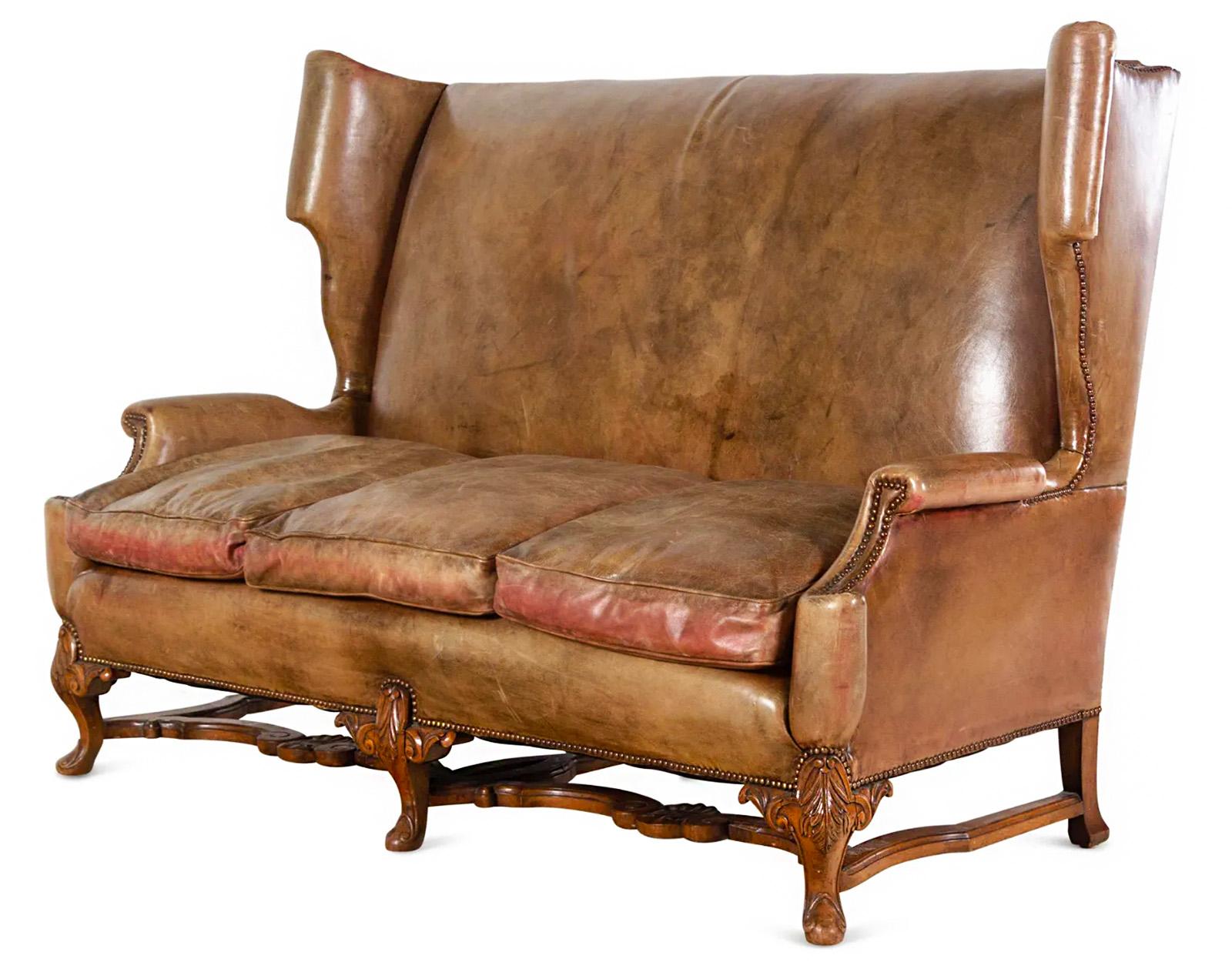 An early 20th century English leather wingback sofa.

Dimensions: 49.25