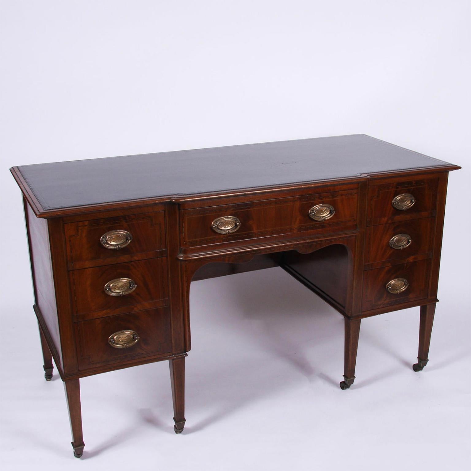English early 20th century

A large mahogany kneehole desk with leather top. 
         