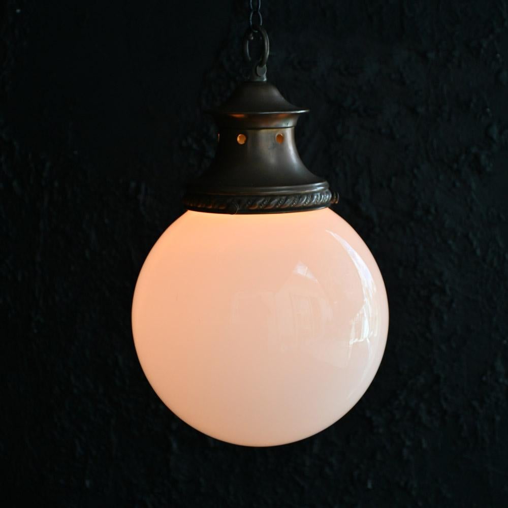 Early 20th Century English Milk Glass & Copper Light    
An Early 20th Century English milk glass stamped copper gallery ceiling light. This example comes with its original gallery, which is stamped PROV.PAL.No 412/26. The gallery displays a nice,