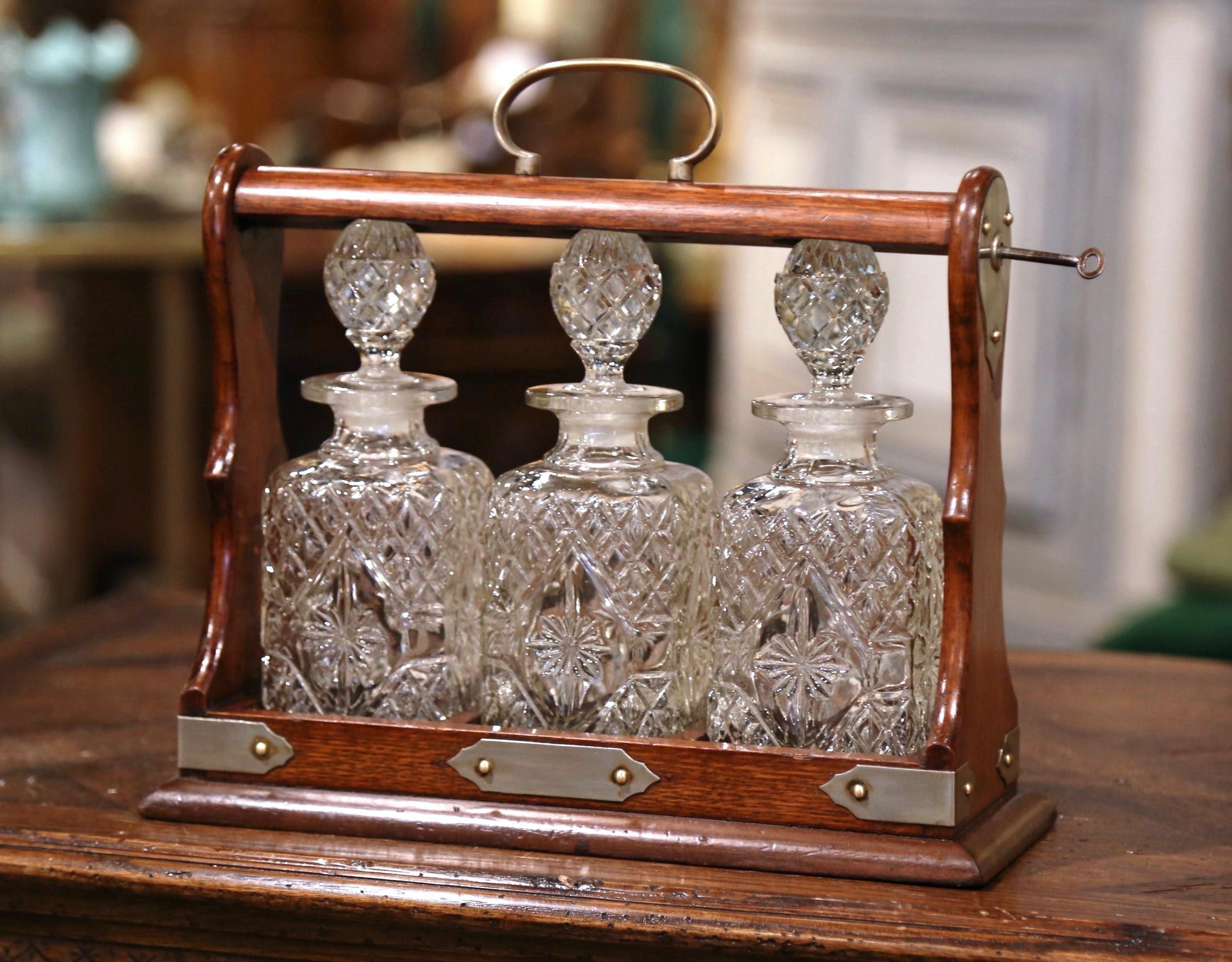 Hand-Carved Early 20th Century English Oak and Brass Tantalus with Cut-Glass Decanters