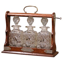 Early 20th Century English Oak and Brass Tantalus with Cut-Glass Decanters