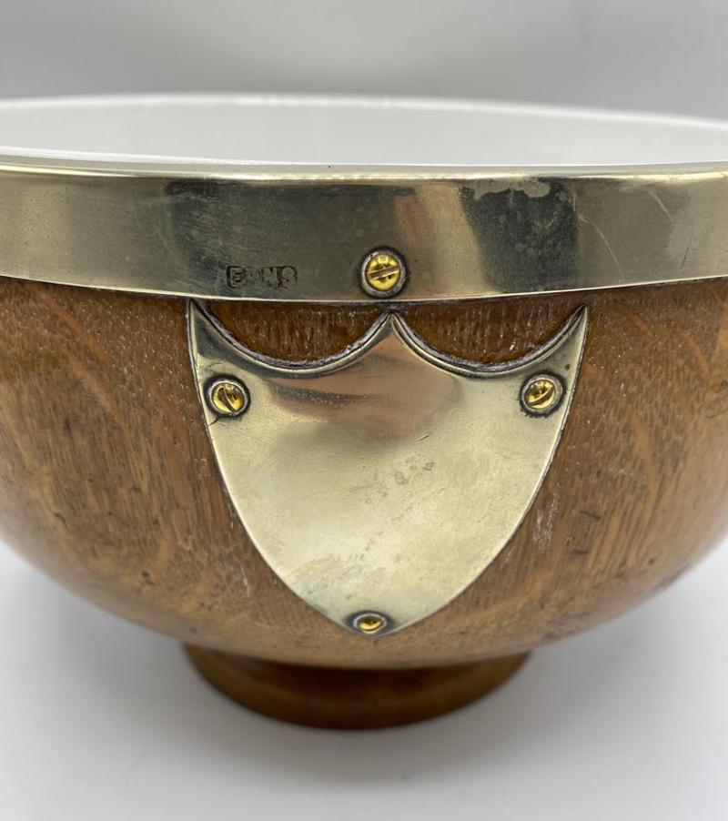 Early 20th Century English Oak and Silver Plate Salad Bowl with Ceramic Insert. 
Add this elegant bowl to your tabletop decor for a regal look. 
England, circa 1900-1910
Measures: 6