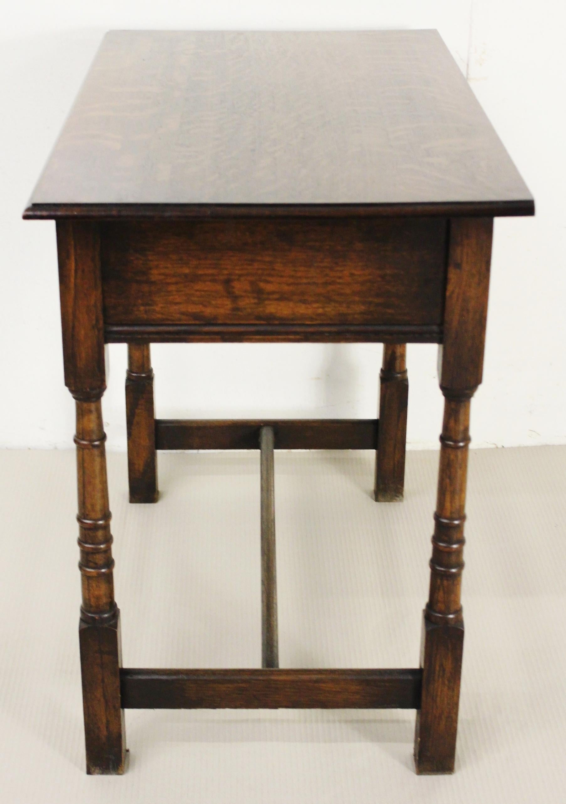 A charming 2 drawer oak side table. Well-constructed in solid English oak. Each drawer fitted with nice original brass drop handles. Offered for sale in very good condition with a great colour and patina ready to go straight into the home.