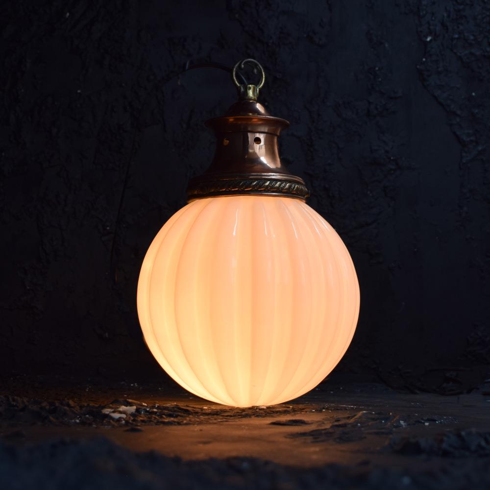 Early 20th Century English Opaline and copper ribbed light shade 

An early 20th century opaline glass ribbed sphere light with its original copper gallery, stamped Railware British Made. 

Size in inches: H 16” x W 10” x D 10”

Completely