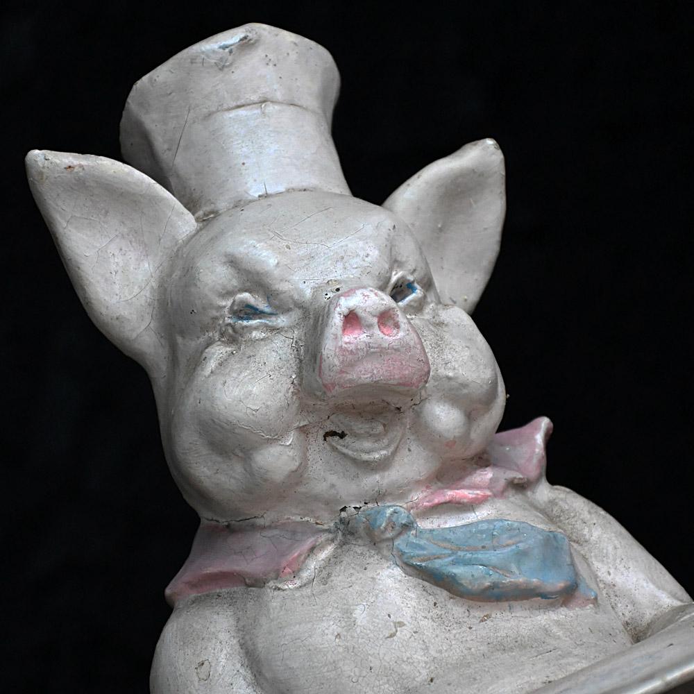 Early 20th century English papier Mache butchers shop display pig figures

A pair of quirky and authentic early 20th century English papier Mache butchers shop display pig figures. One with a papier Mache base and the other with a pine base which