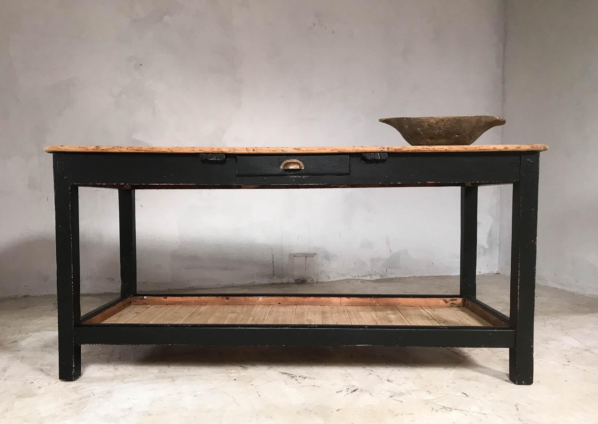 Great looking English pine potting board table in later black paint. Features single drawer in the front with brass cup handle, ample storage on the pine potting boards and beautifully aged original pine top. Attractive piece from front and