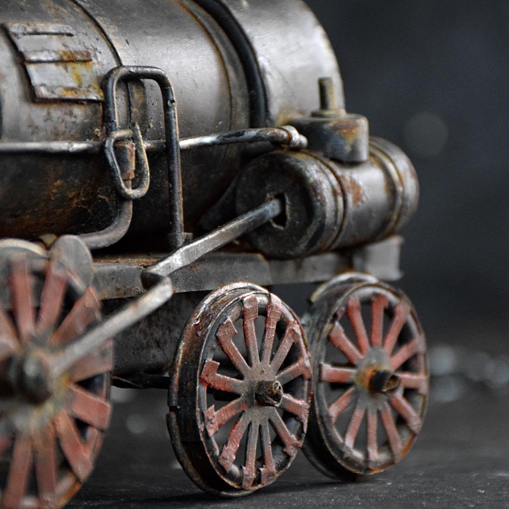 Early 20th century english scratch built train model

Made from found and hand-crafted sections of metal this charming object depicts a train locomotive model. A static object, aged and fragile, it hasn’t lost its simple if somewhat naïve folk-art
