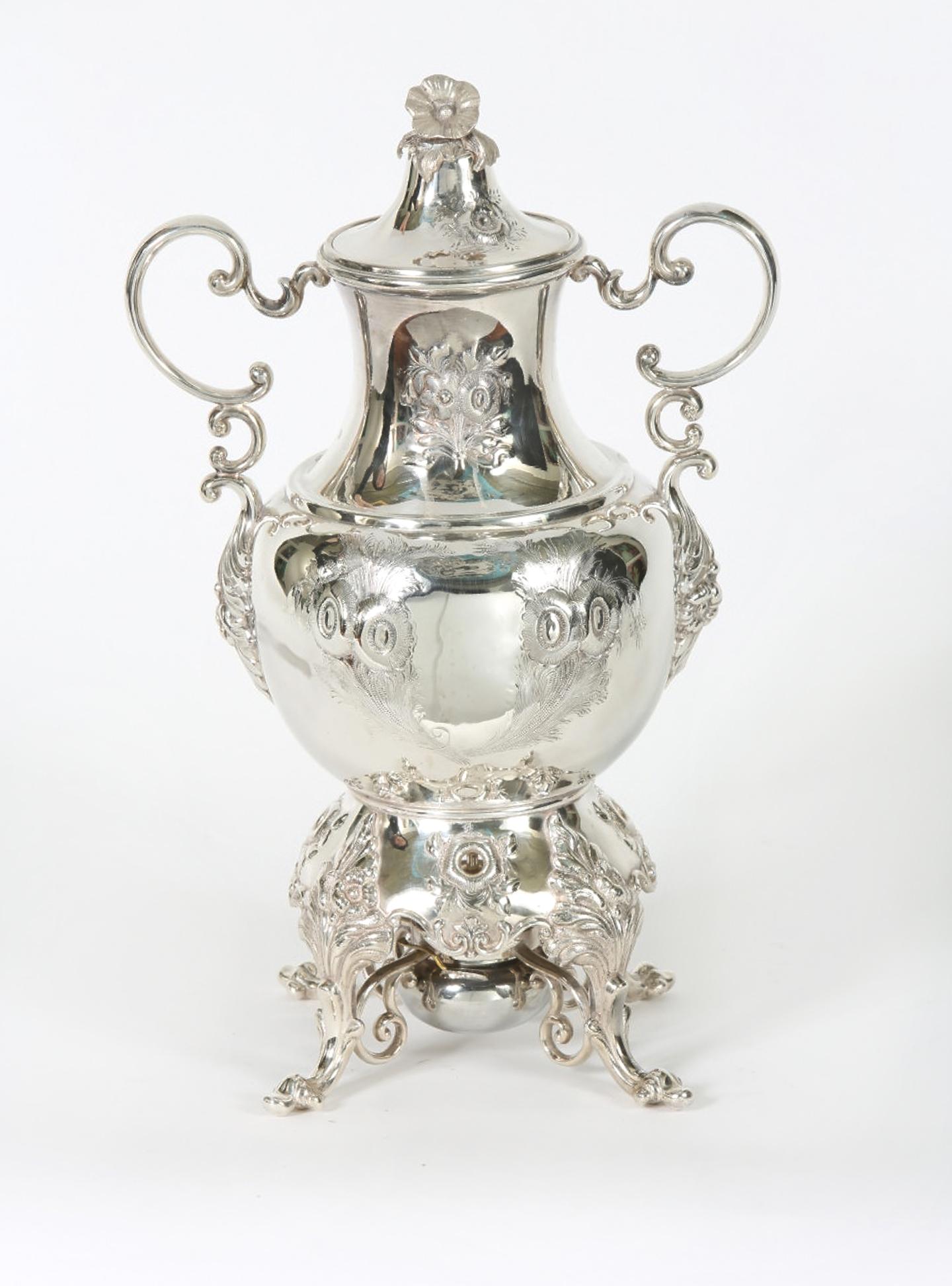Early 20th century English silver plated footed hot water samovar with exterior design details / flame burner. The samovar is in excellent antique condition. Minor wear consistent with age / use. Maker's mark undersigned and numbered. The samovar