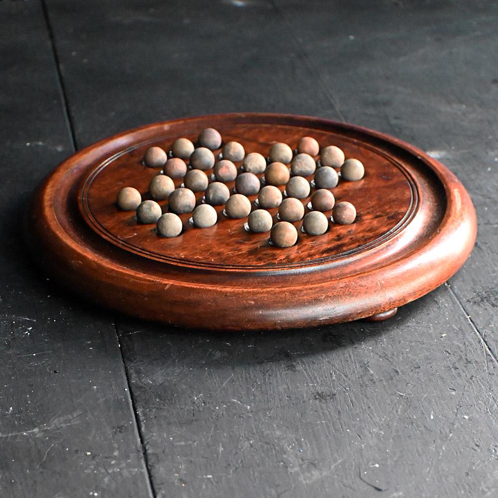 Early 20th Century English Solitaire Game Board 

A nice example of an early 20th century English wooden solitaire game board with stone coloured playing balls. With a deep natural patination across all its surface due to age and hour of