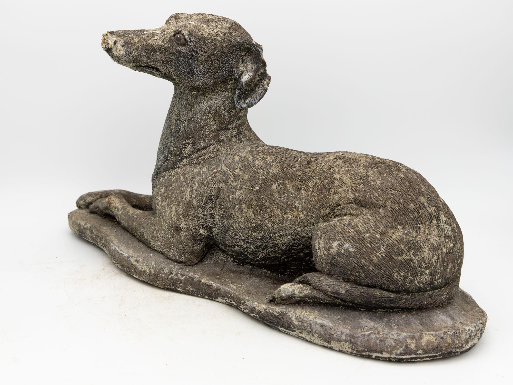 This exquisite garden ornament is a captivating portrayal of a recumbent whippet, epitomizing grace and charm. Crafted with meticulous attention to detail, the sculpture captures the whippet's serene repose, its slender body elegantly stretched out.