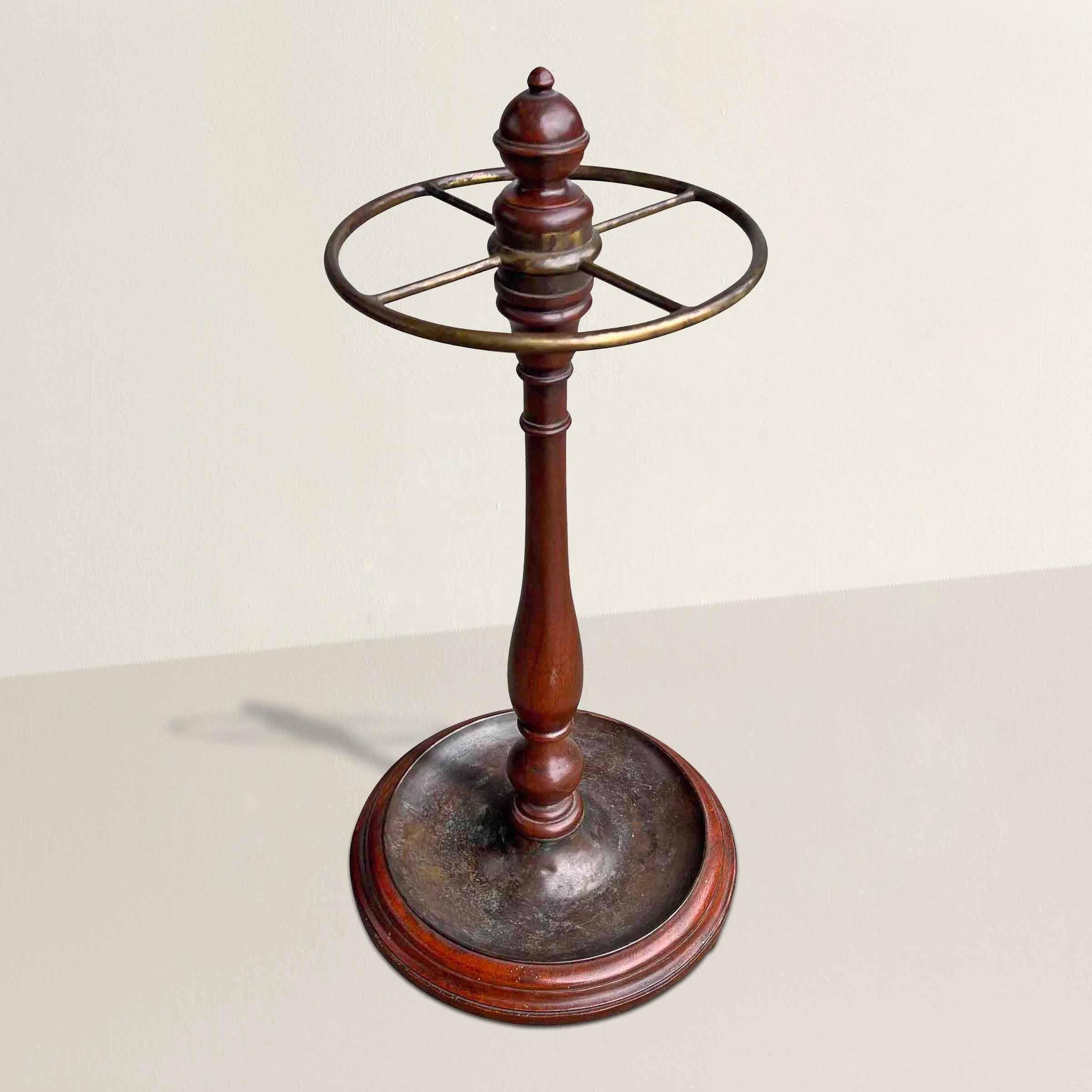 Transport yourself to the elegant world of early 20th-century England with this Edwardian period turned wood and brass umbrella stand. Reflecting the stylistic characteristics of the Edwardian era (1901-1910), this piece marries exquisite