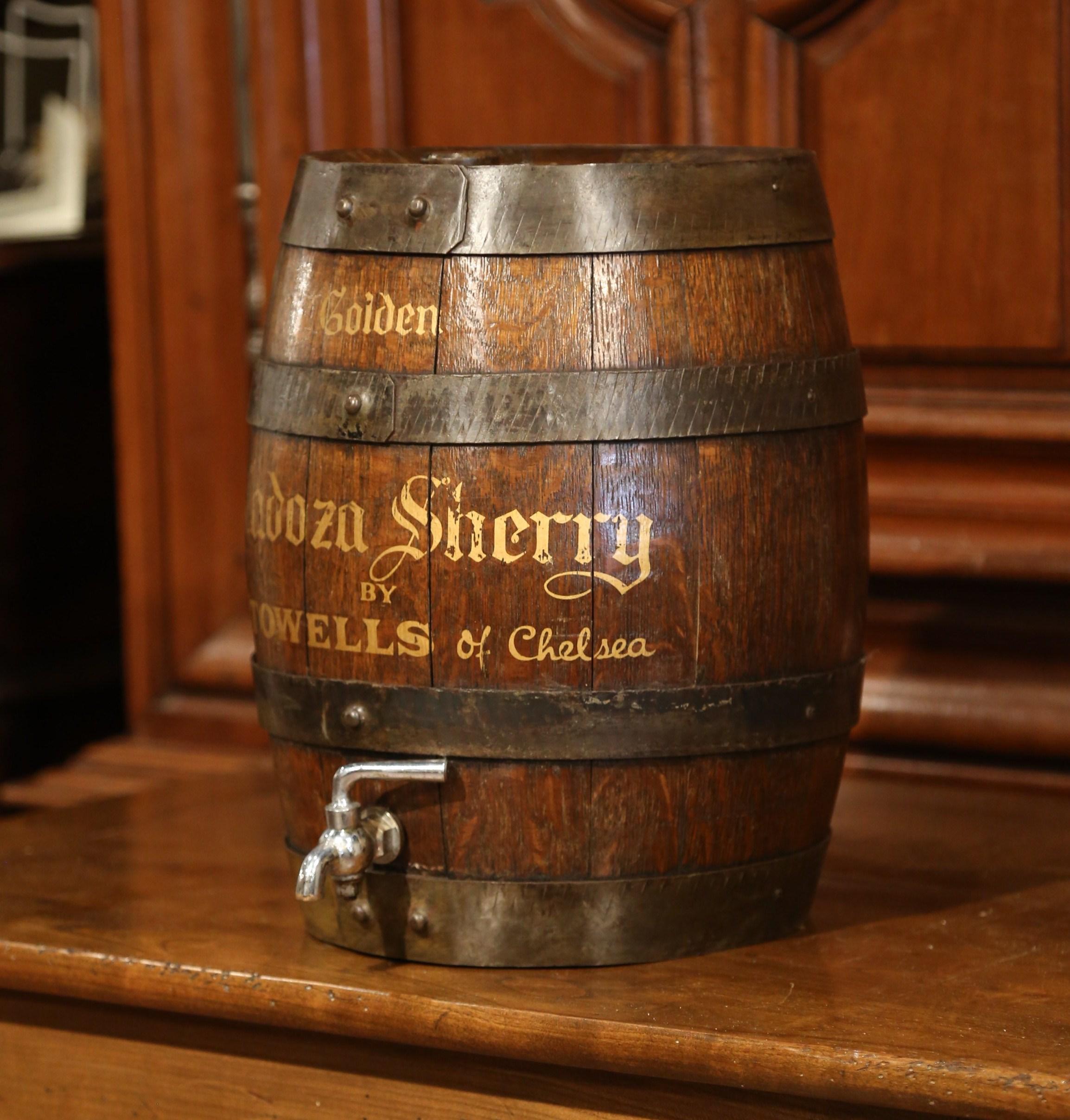 Decorate your bar with this beautiful, vintage oak Cadoza Sherry barrel. Crafted, circa 1920, the great, old barrel features full oak construction, studded metal bands, a charming, small nickel tap and a tapered wooden cork at the pediment. The