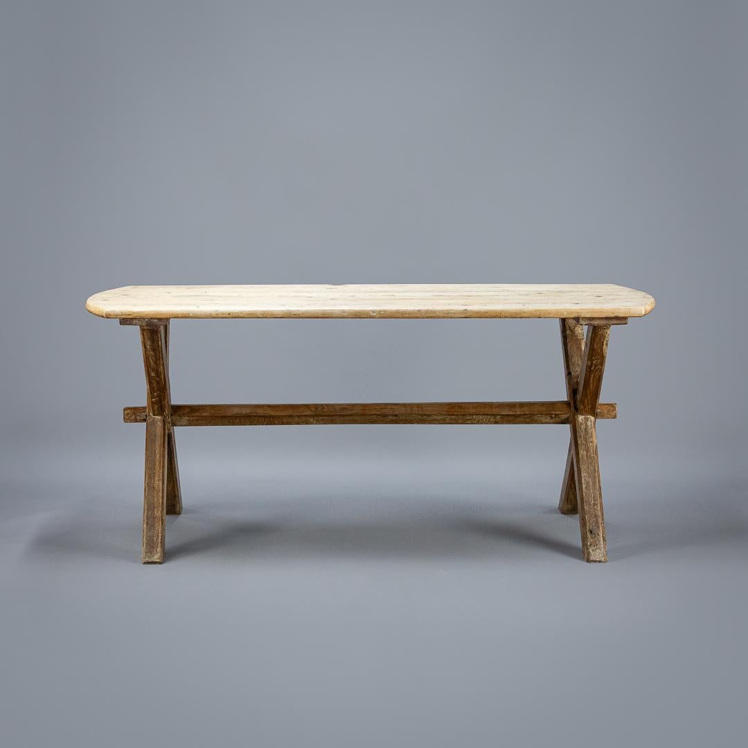 X-frame tavern table, pale scrub top with well patinated oak base, England, circa 1900.
Dimensions: 181cm x 80cm x 63cm.
 
