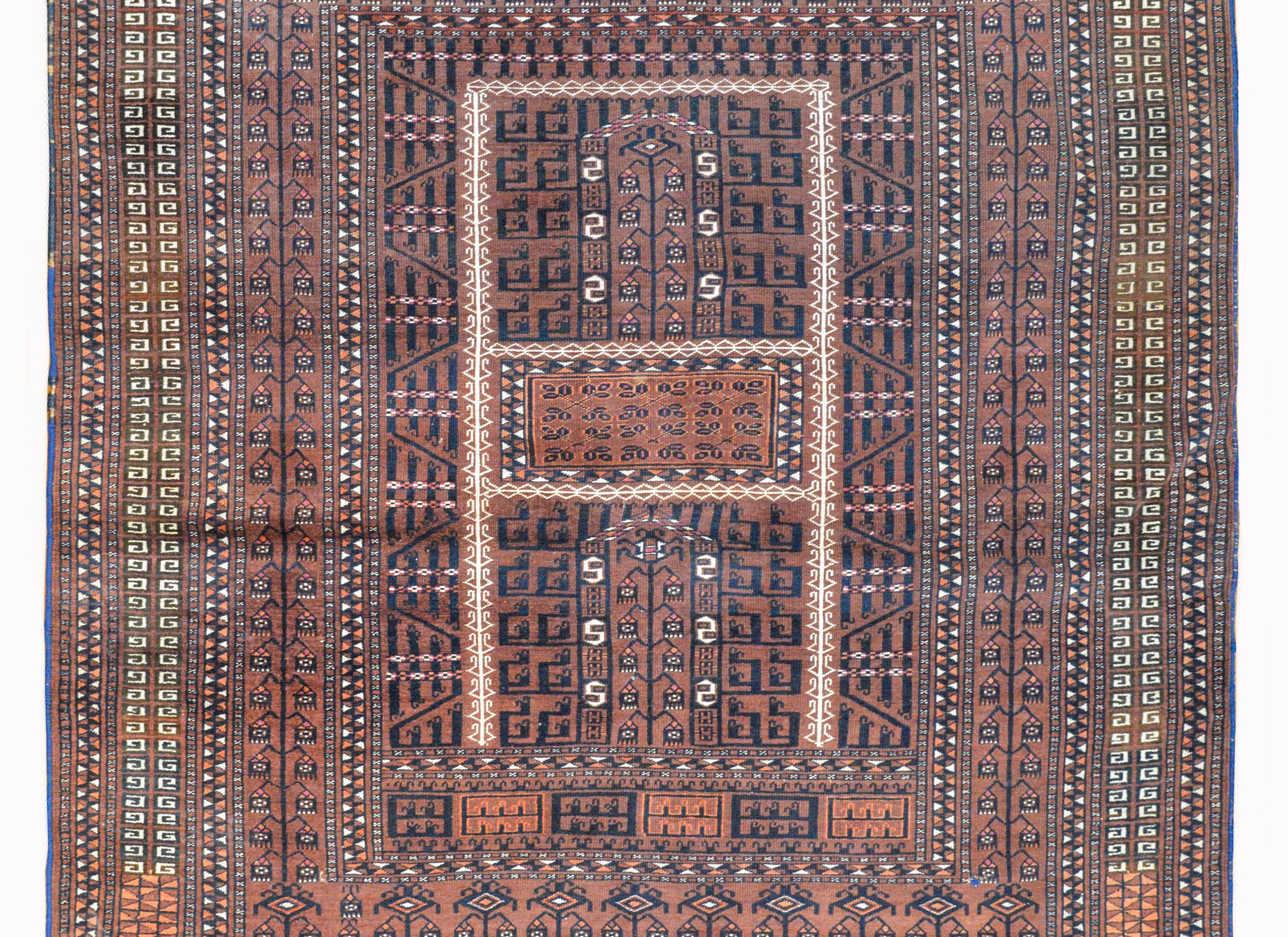 A fantastic early 20th century Persian Ensi rug with an all-over tribal geometric pattern woven in black, white, crimson, and orange, against a brown background.