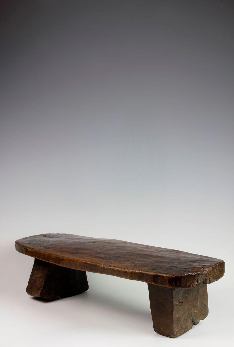 This stool, from the Gurage culture of Ethiopia, has been carved from a single piece of heavy, dense wood. The stool exhibits a flat, low form and over time, has developed a lovely deep, glossy surface patina as a result of use.

Estimated Period:
