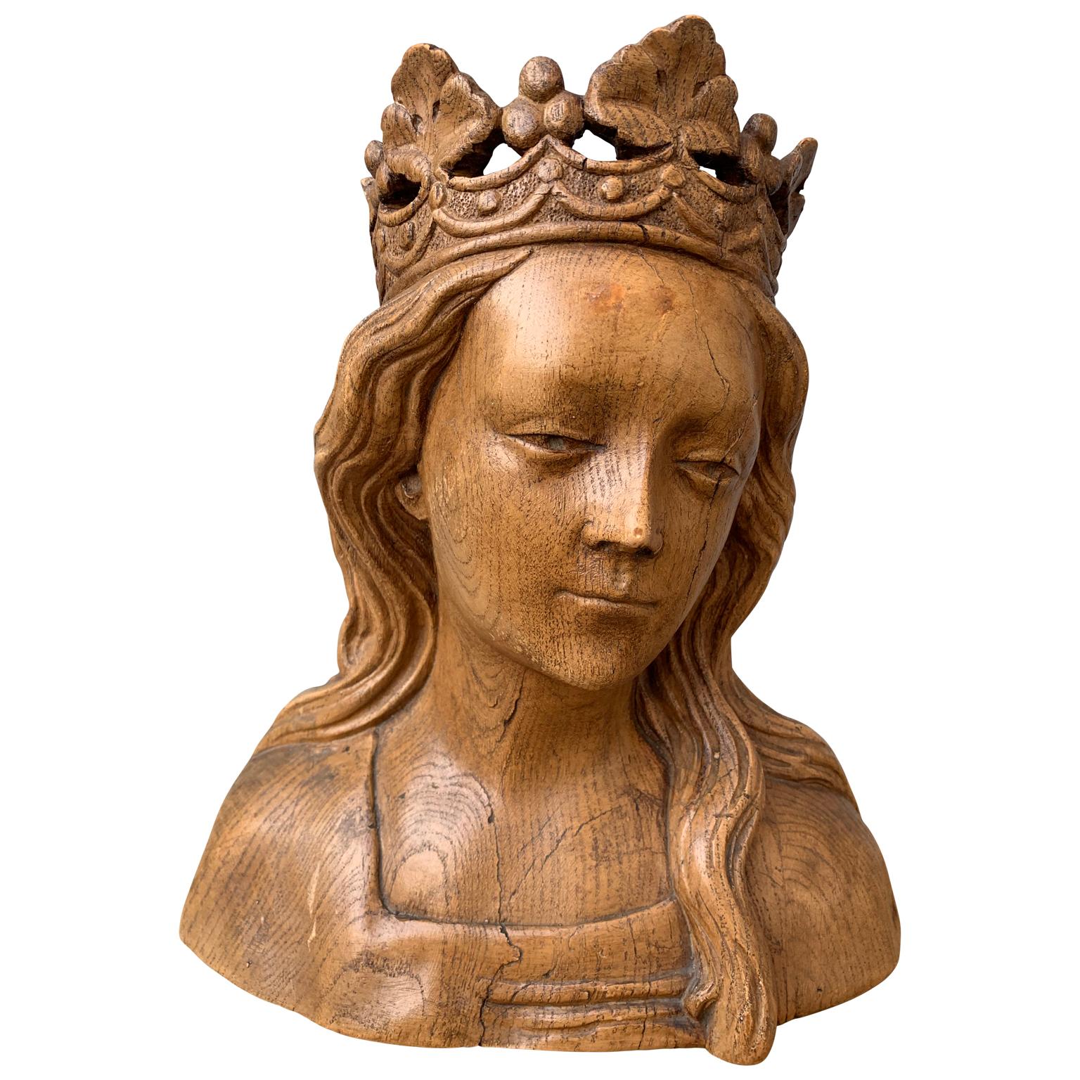 An early 20th century sculpture of the Virgin Mary. The terracotta figure is painted in the 