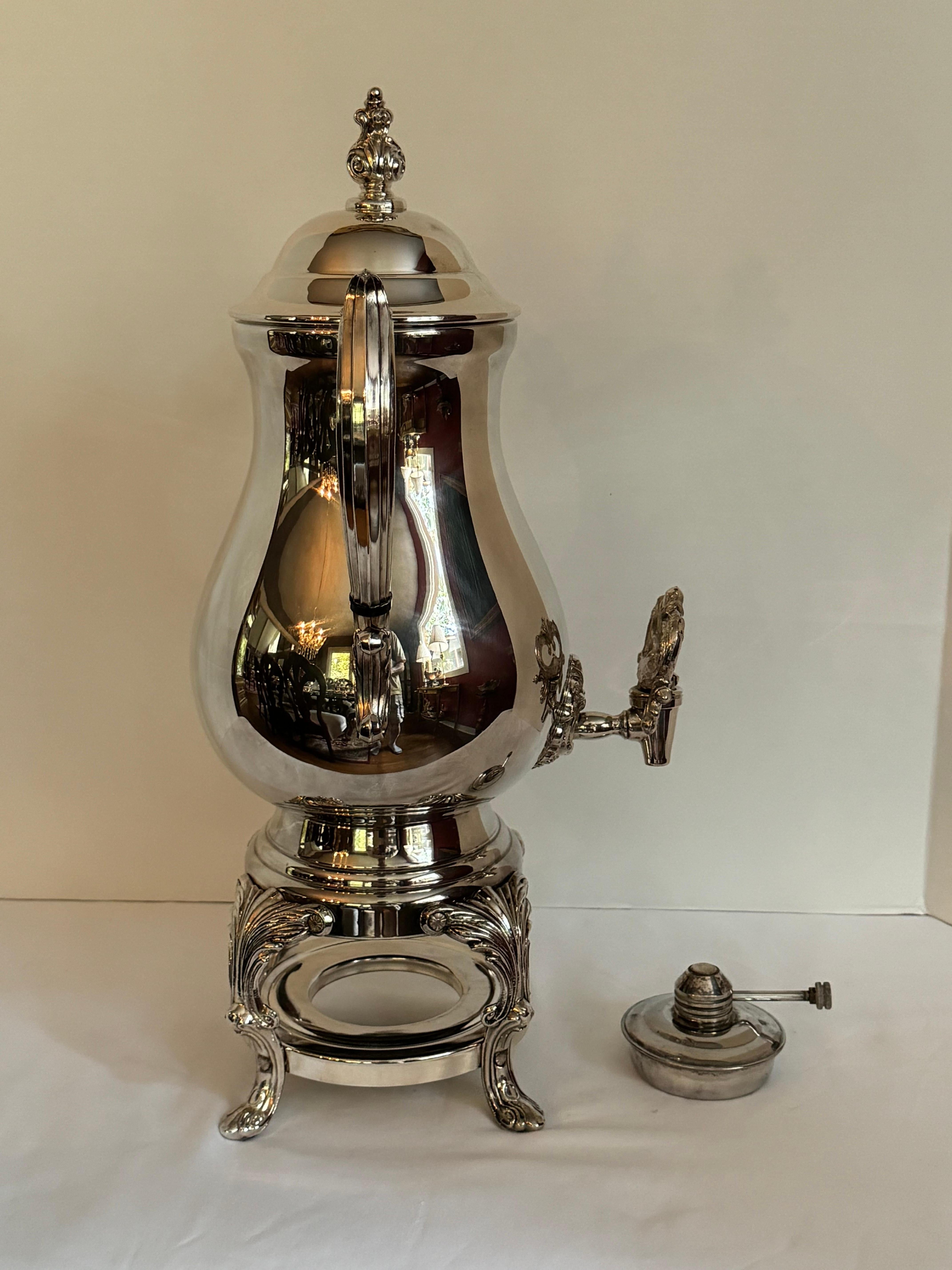 Silverplate Samovar, Coffee Urn, With Lid and Ebony Insulators.
This is a fabulous coffee or hot water urn, by BF rogers Silver Company curved at the bottom of the urn . It has the burner can in the base to keep the coffee/water warm. It even has 4