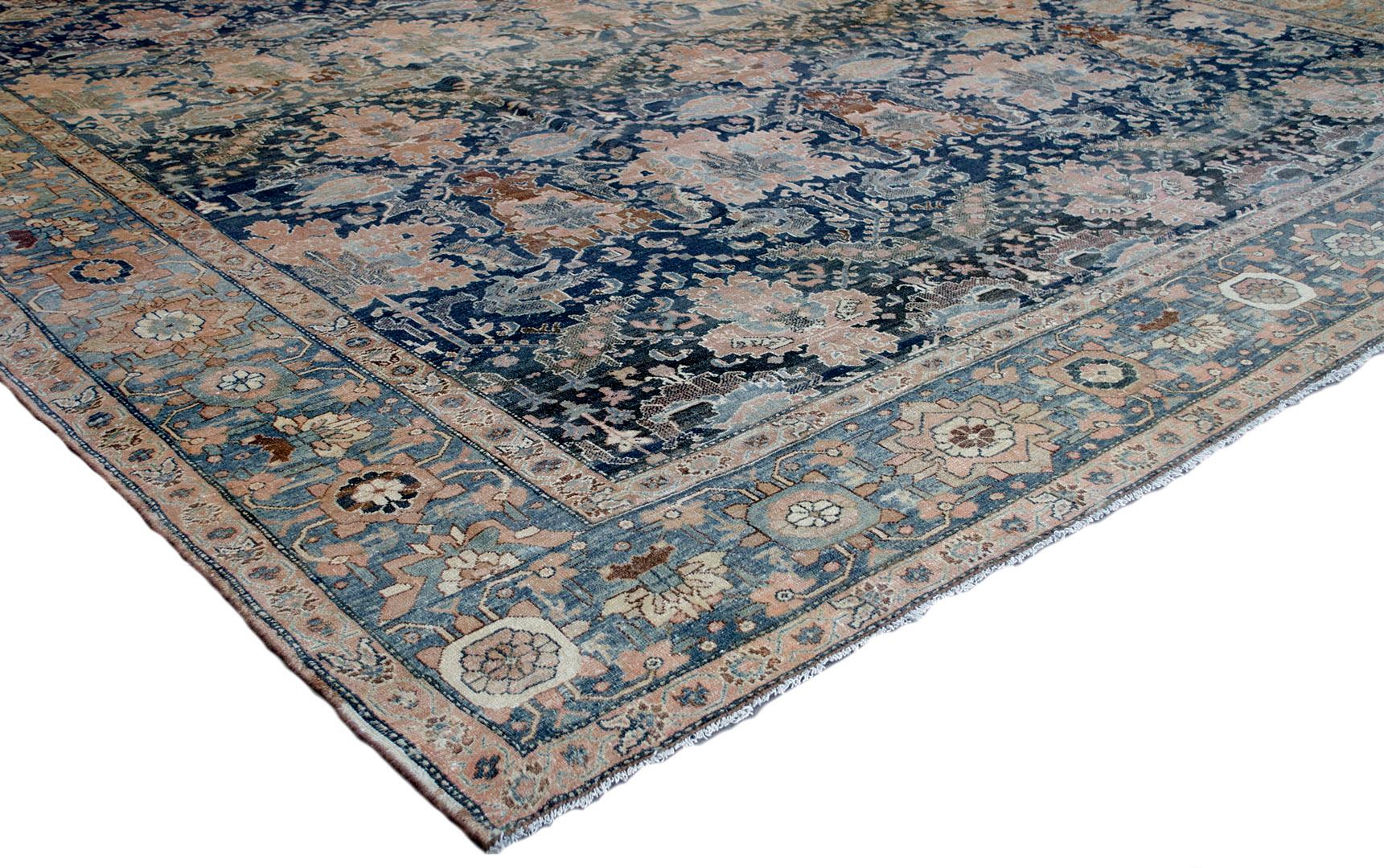 This traditional handwoven Persian Fereghan rug has a shaded navy all over field of ornate palmette rows issuing dense floral and vine motif, in a shaded medium blue border of dense linked palmette pendants, between regal golden vine stripes.