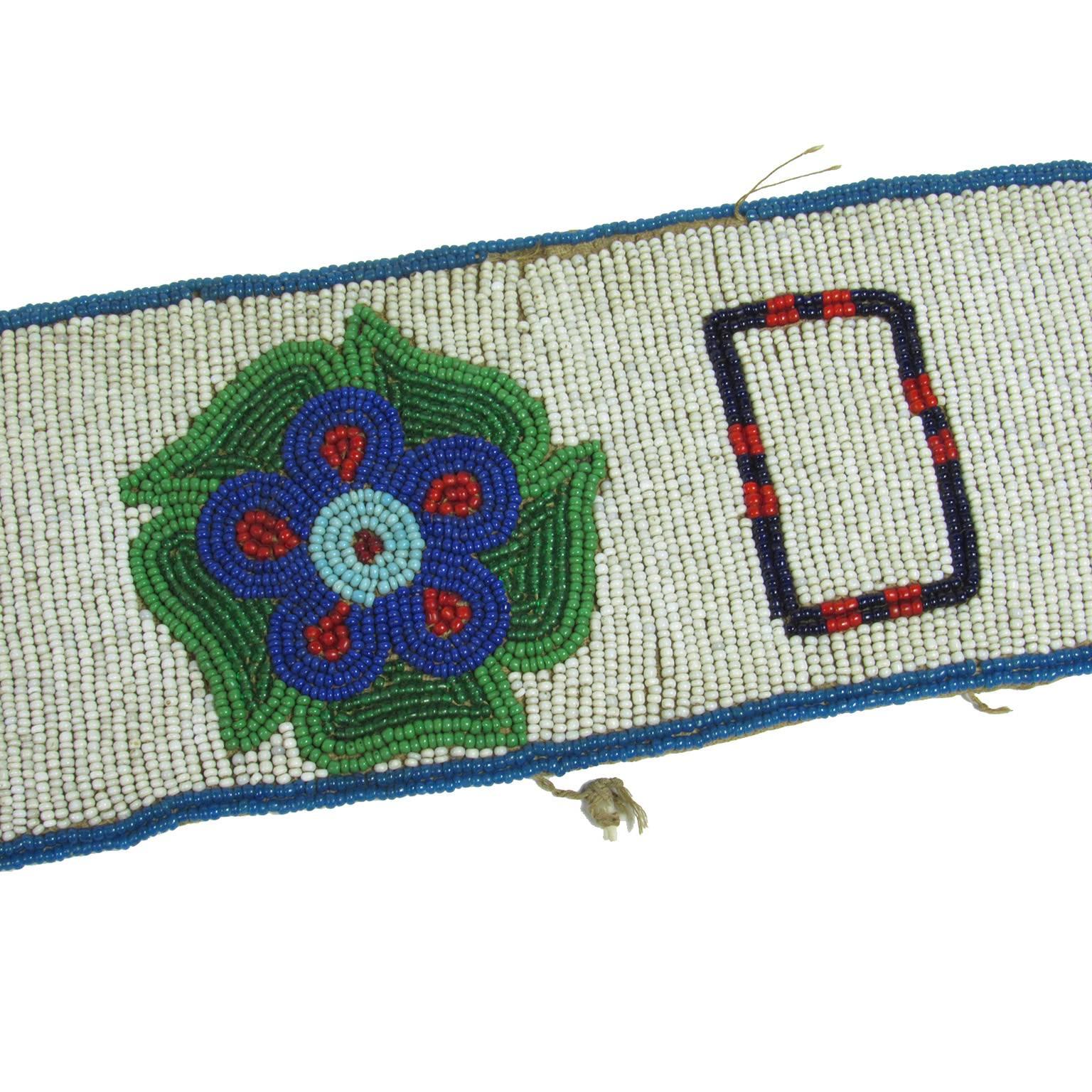 First Nations Cree Reservation bead work belt, Canada, circa 1917. A ground of white beads with seven multicolored flowers decorating the band. Signed and dated on verso 