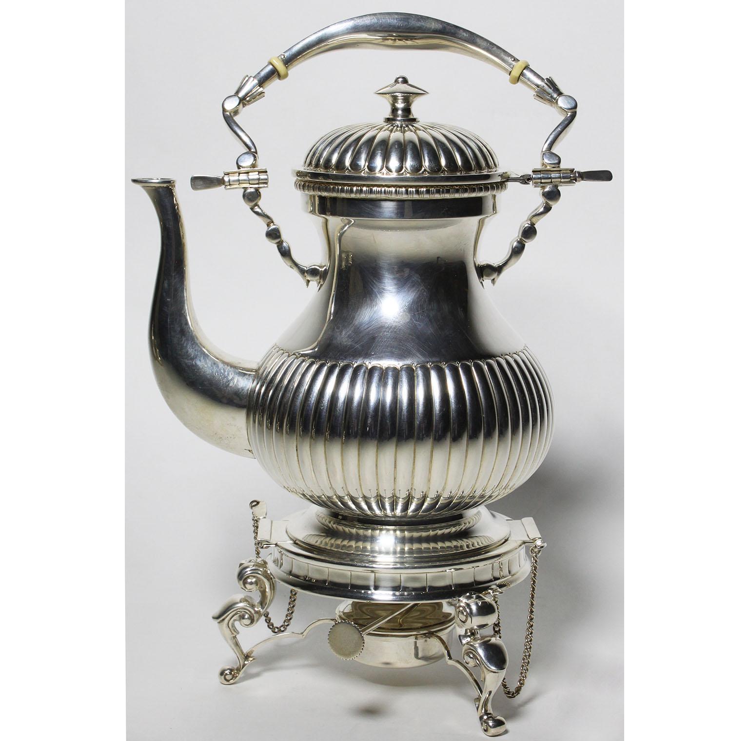 A very fine early 20th century five-piece Louis XV style sterling silver tea and coffee service set. The finely chased ovoid shaped body with scalloped details and vermeil gold interior, comprising of a large hot-water samovar kettle on a tilt-stand