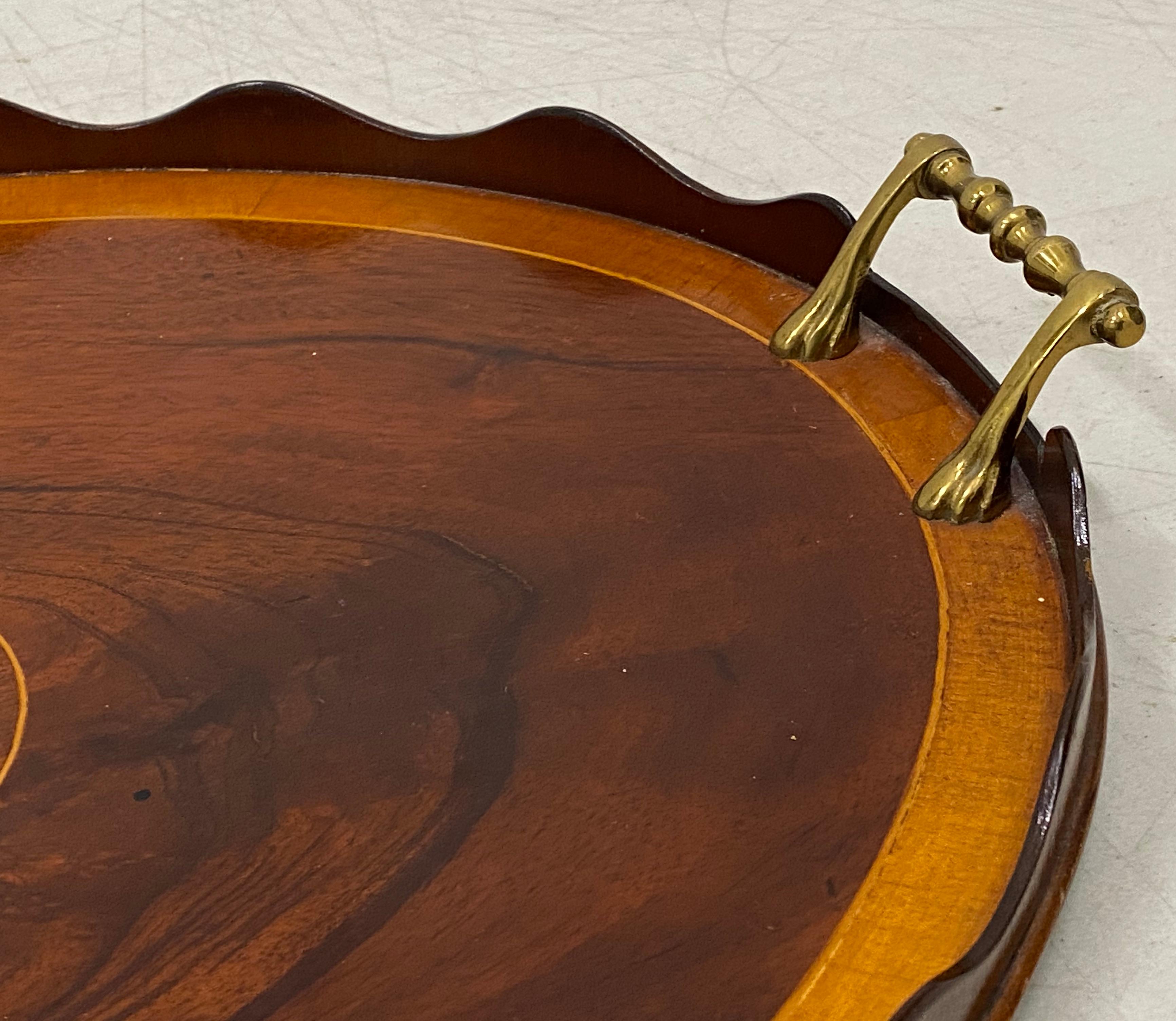 Early 20th century flame mahogany serving / bar tray with shell inlay

Gorgeous handcrafted serving tray with scalloped edge

Very nice antique condition

Dimensions: 22.5