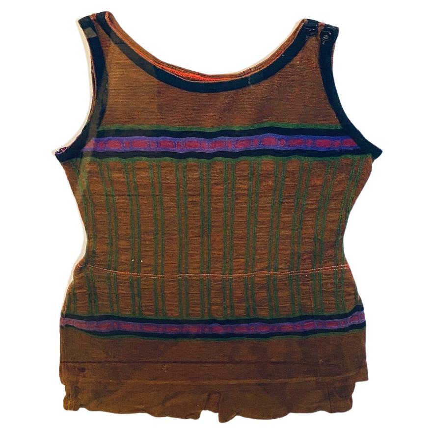 Early 20th Century Flapper's woolen swim suit, circa 1920s, a Roaring 20s period woolen one-piece woman's bathing suit with classic Art Deco stripes The suit has muted black, green, purple and red stripes on brown fabric.

The swim suit remains in