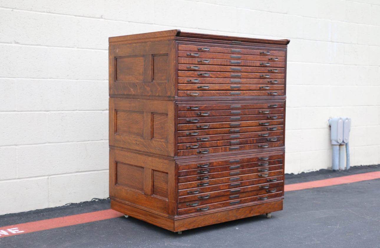 Beautiful flat file cabinet made of solid oak wood. This cabinet is made up of three parts, “plus top and base.” Each section has eight drawers. This cabinet has wheels. The cabinet is in vintage condition, it has some wear due to age and use, ( you
