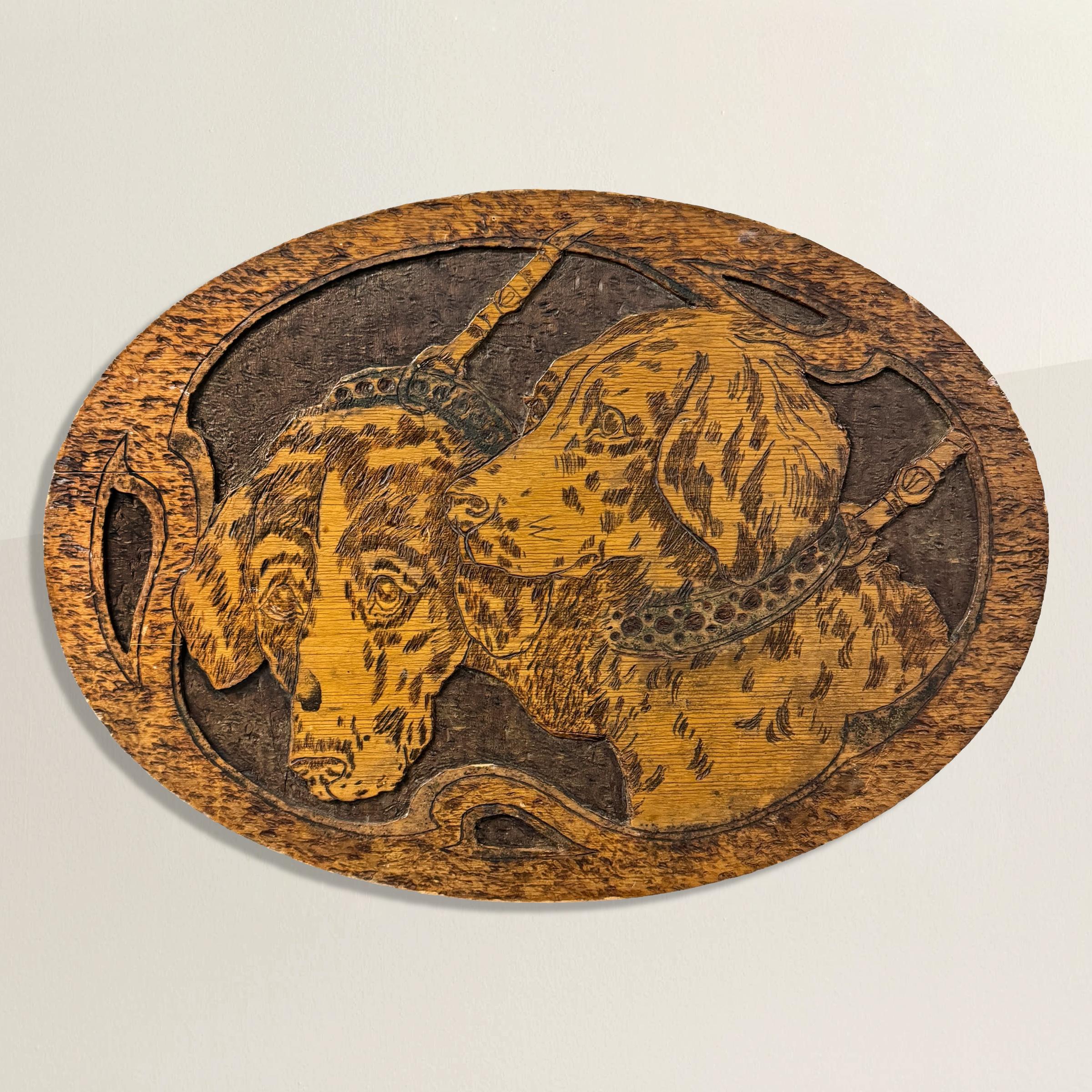 This early 20th-century Flemish low-relief panel showcases the exquisite artistry of pyrography, a technique where designs are burned into wood using a heated tool. Here, two hunting spaniels adorned with studded collars and leashes are meticulously