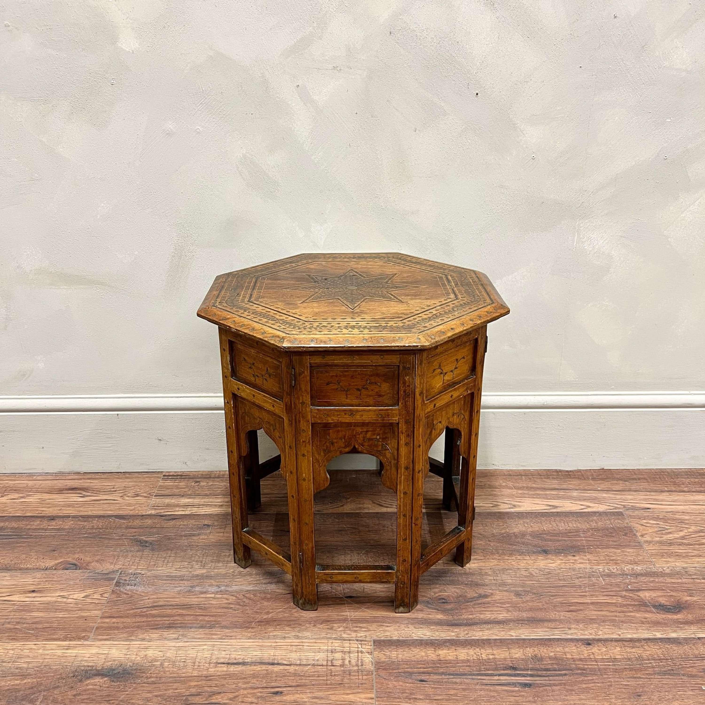 An early 20th Century folding Hoshiarpur Table
Decorated with traditional brass inlay work throughout, with hinges.
India, circa 1940.

Height: 47.5cm
Width: 46cm
Depth: 46cm

Please do message us for any further information, photographs or