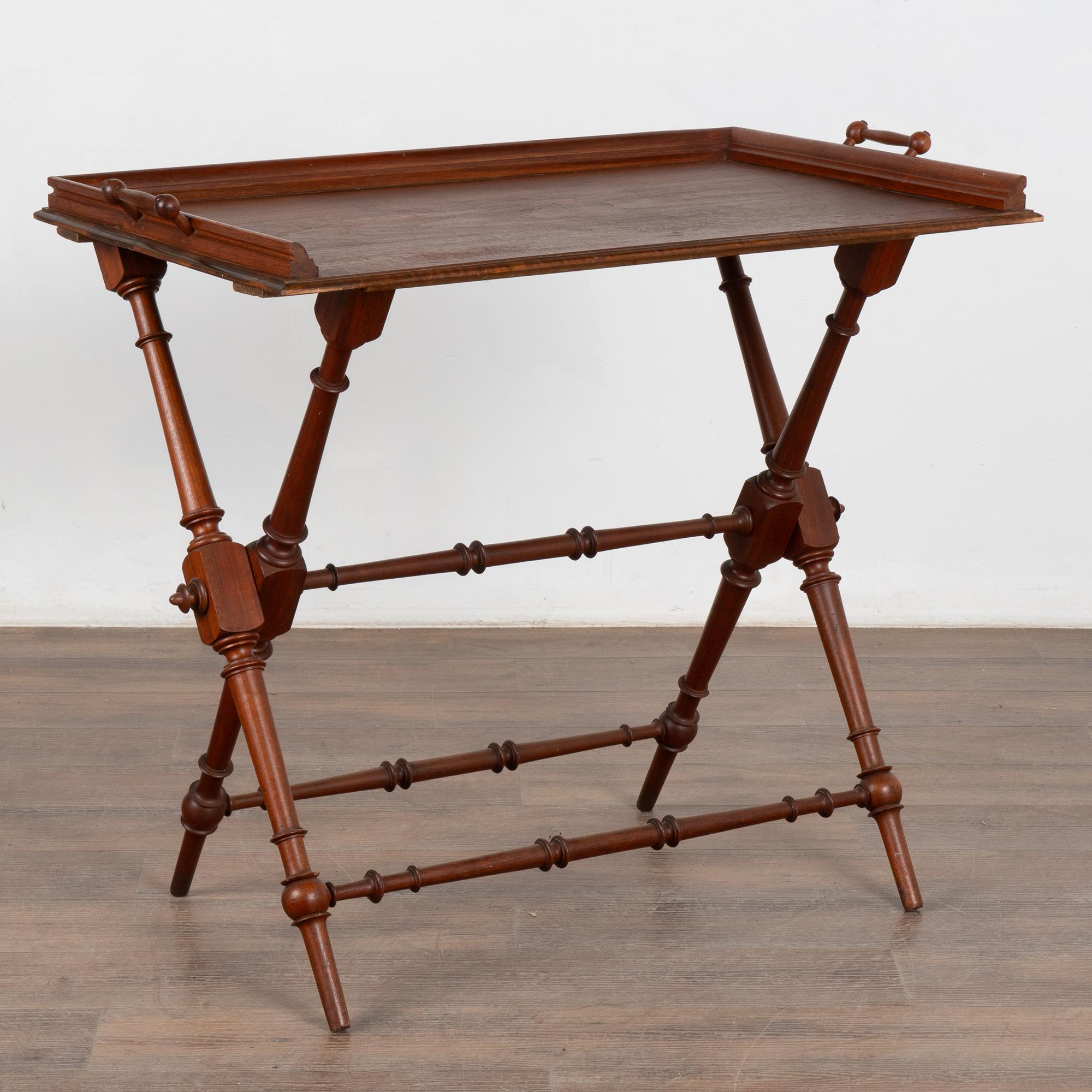 There is great character packed into a small space in this unique tea table with it's removable tray that rests on a X base stand with turned legs. The tray has handles on each side.
Restored and ready to use.
All scratches, cracks, dings, and age