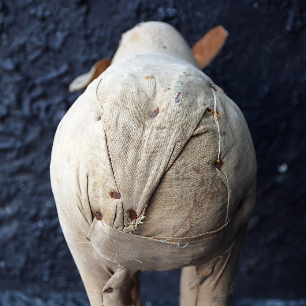 We are proud to offer an early 20th century handcrafted Folk Art figure of a cow. Made from hand carved wood, stuffed with sectioned straw, and aged linen body. A highly decorative and unique item, this figure has lots of charm as you can see from