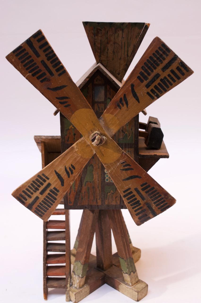 American Folk Art whirligig / birdhouse, crafted to resemble a barn and silo, circa 1920s. Appealing colors and hand painted details. Alternating wooden 'hammers' move in an upward and downward motion by manually moving the windmill (presumably, a