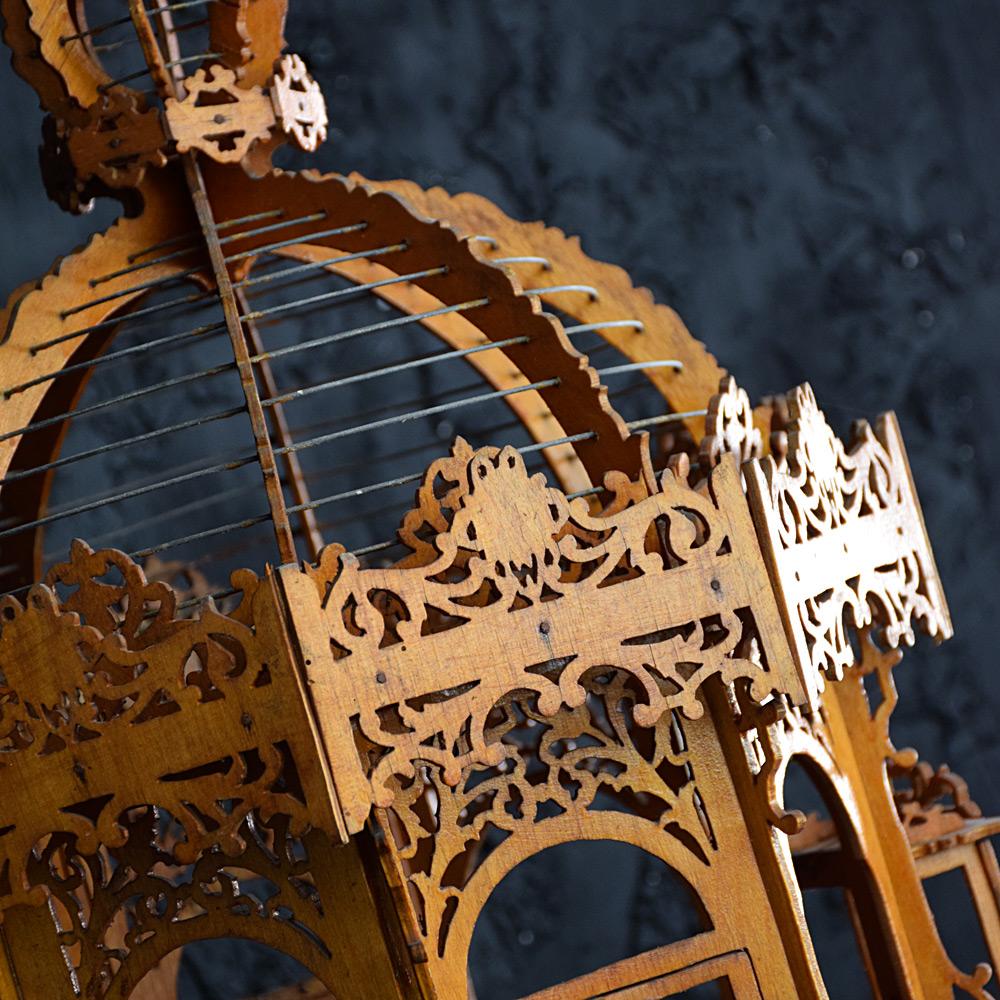 Early 20th century Folk Art handmade bird cage.

We share what we love, and we love the sculptural form of this hand-crafted folk art French birdcage made from old cigar boxes. Refined carved detail including opening windows and metal wire caged