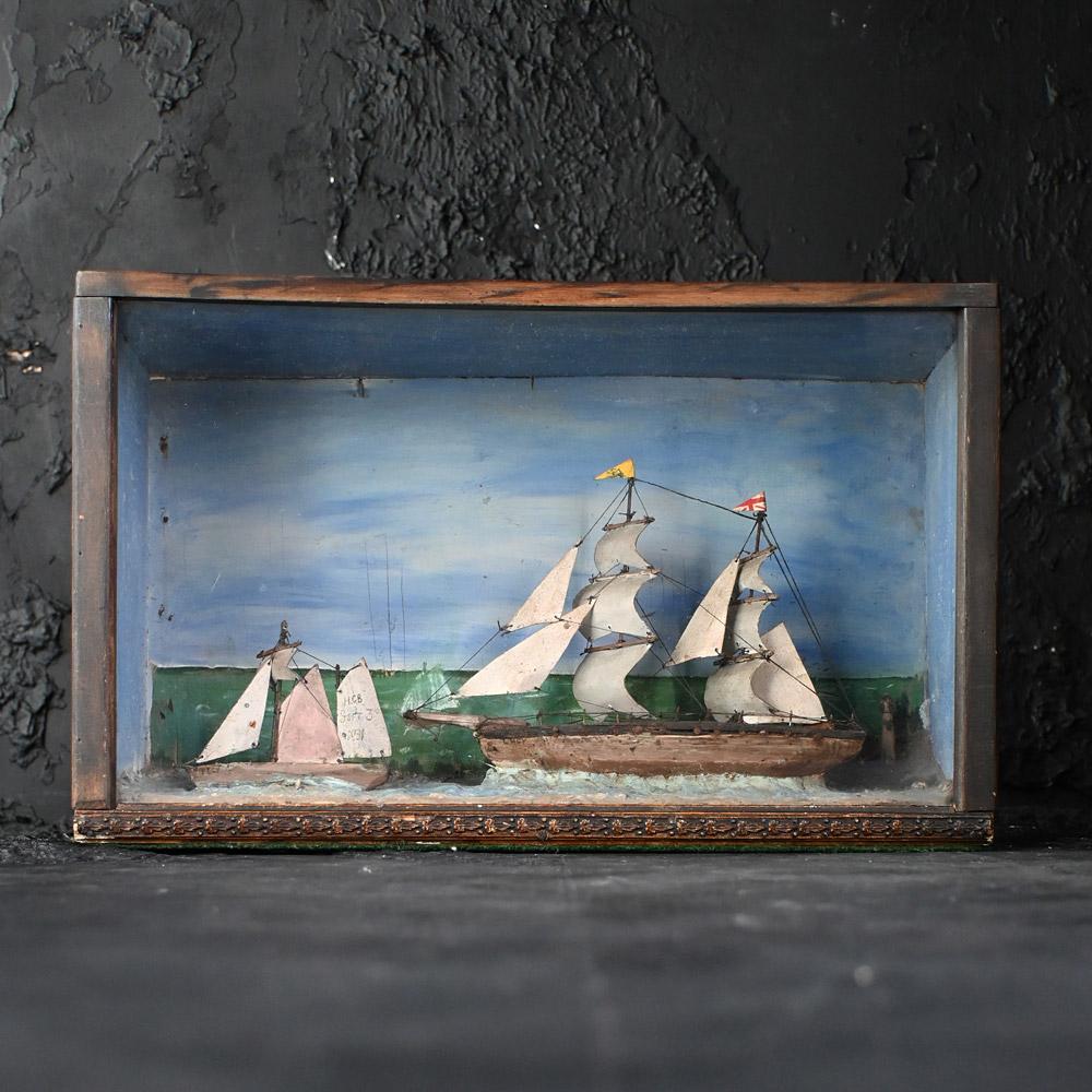 Early 20th century Folk Art ship & sailboat diorama. 

This handcrafted Early 20th century English diorama contains 2 ship models. One of the ships has a British flag flying from its mast, The other has an ink written message stating “HCB Sept 3rd