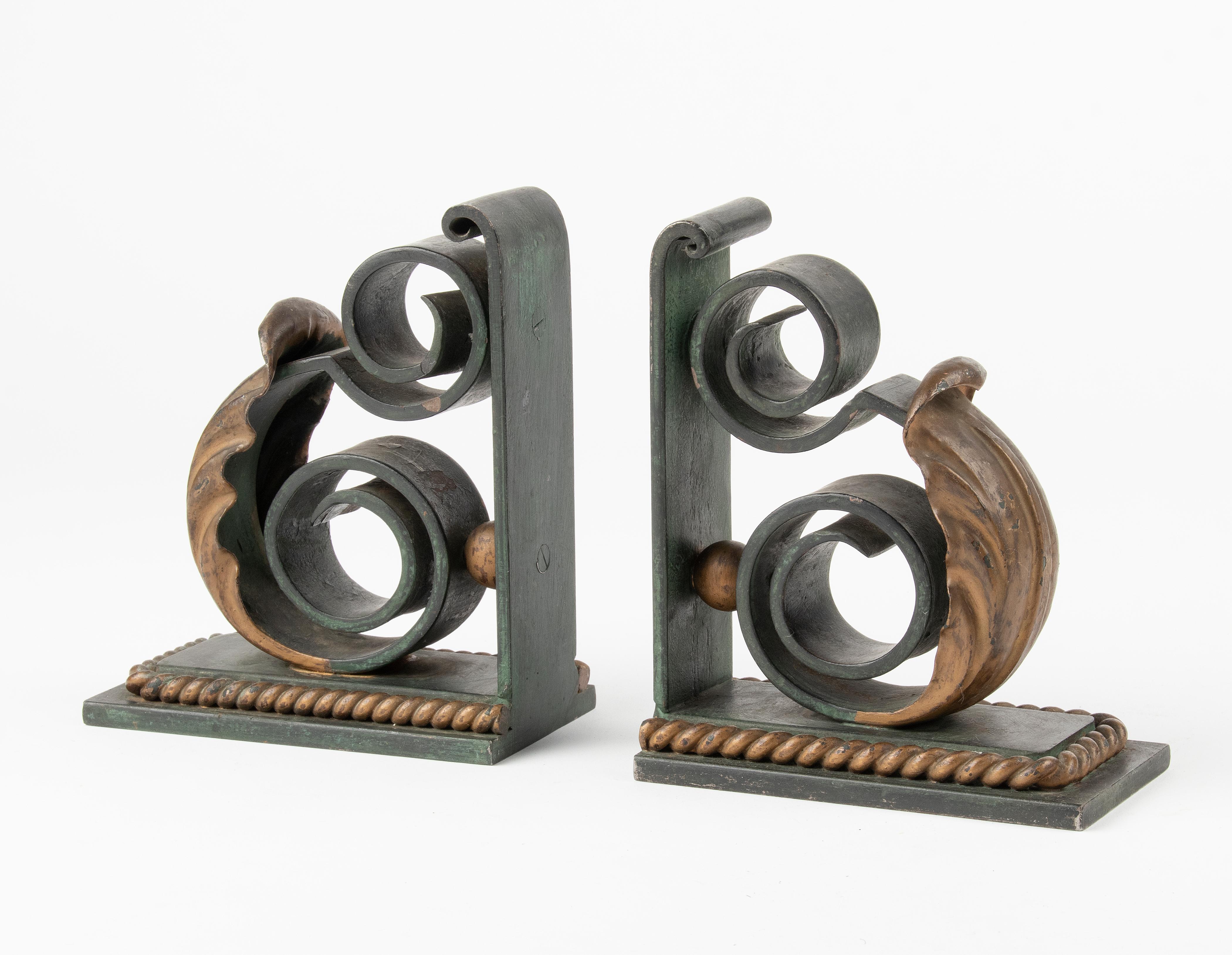 A pair of heavy duty forged iron book-ends. Nicely patinated in green and bronze-like colors. 
The pair is in good condition. Heavy and sturdy. 

