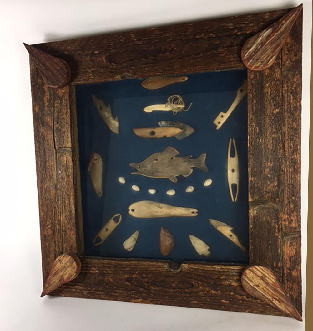 A wonderful collection of early 20th century carved bone fishing hooks and misc fishing gear in a wood frame. Front the Northwest coast of the United States. Inside glass is 16